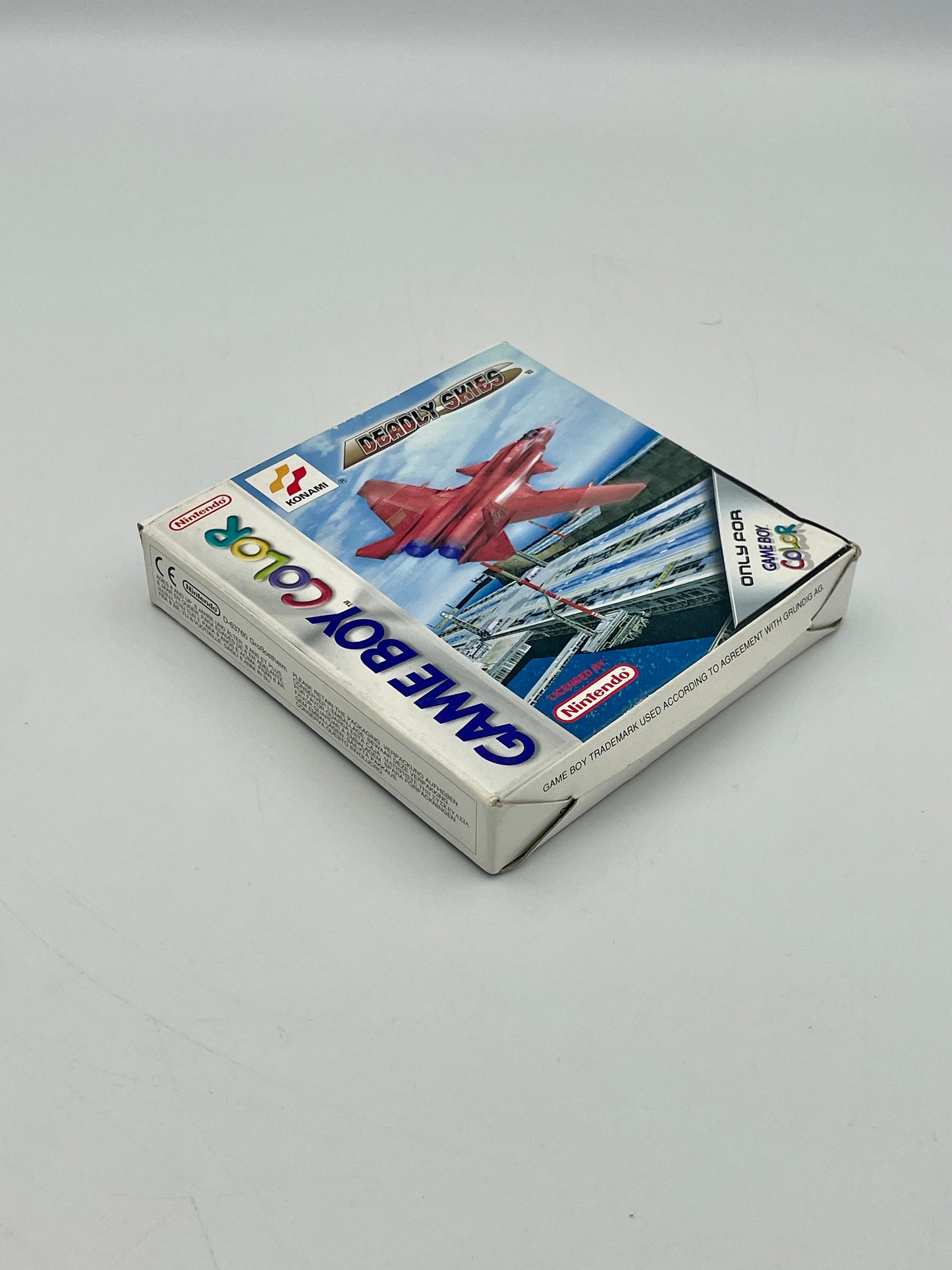 Game Boy Color game cartridge with airplane illustration on a gray background