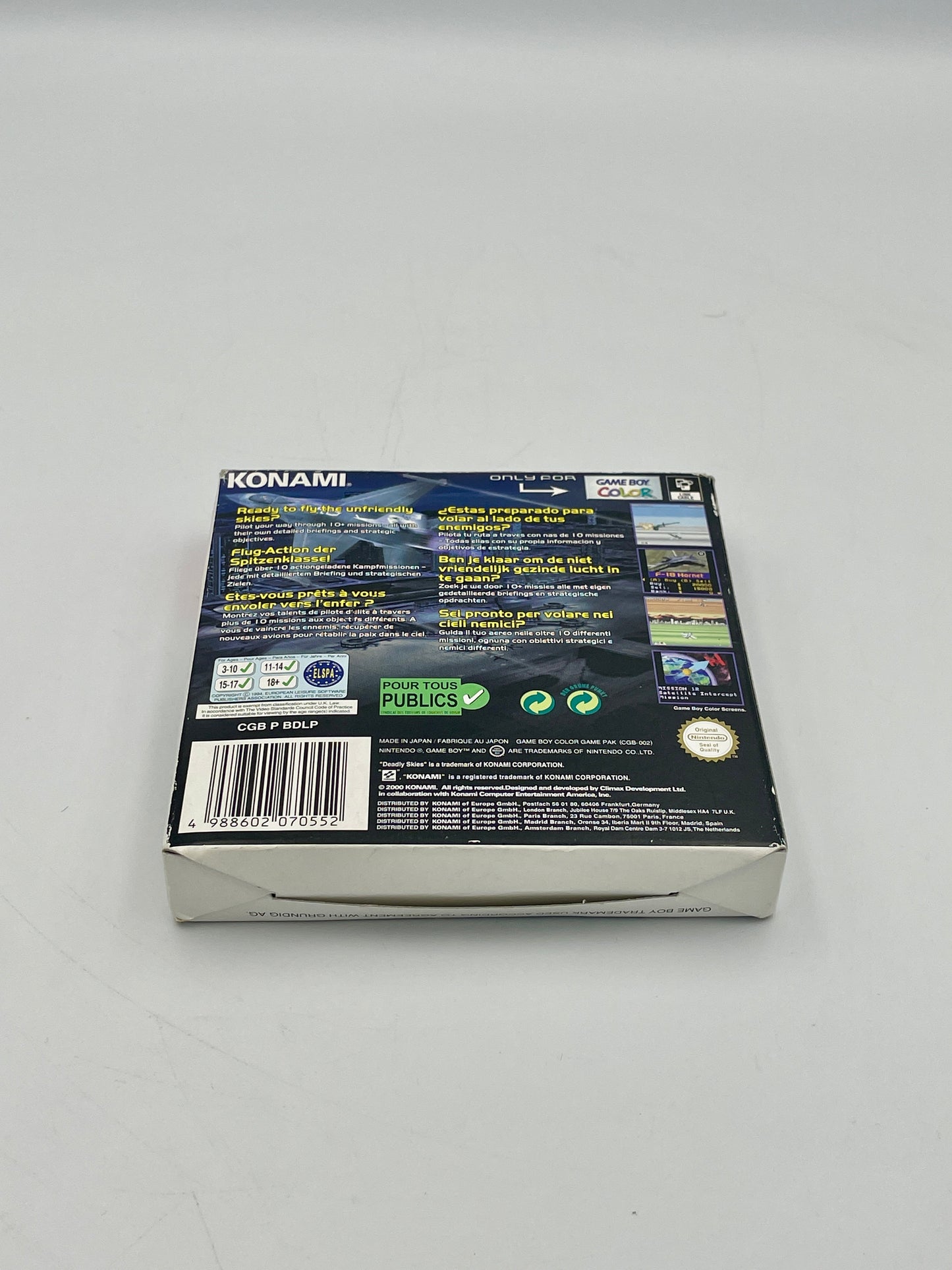 Back view of a Konami game box on a gray background