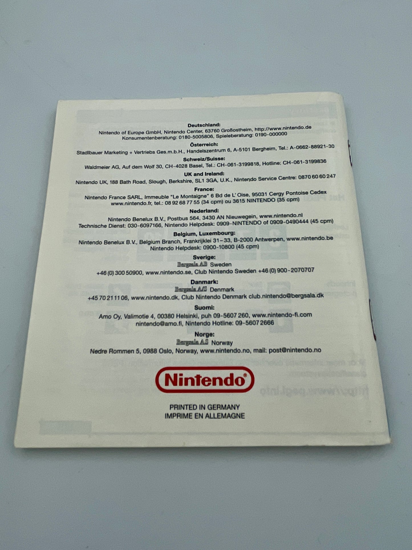 Nintendo product packaging with text and logo on a gray background
