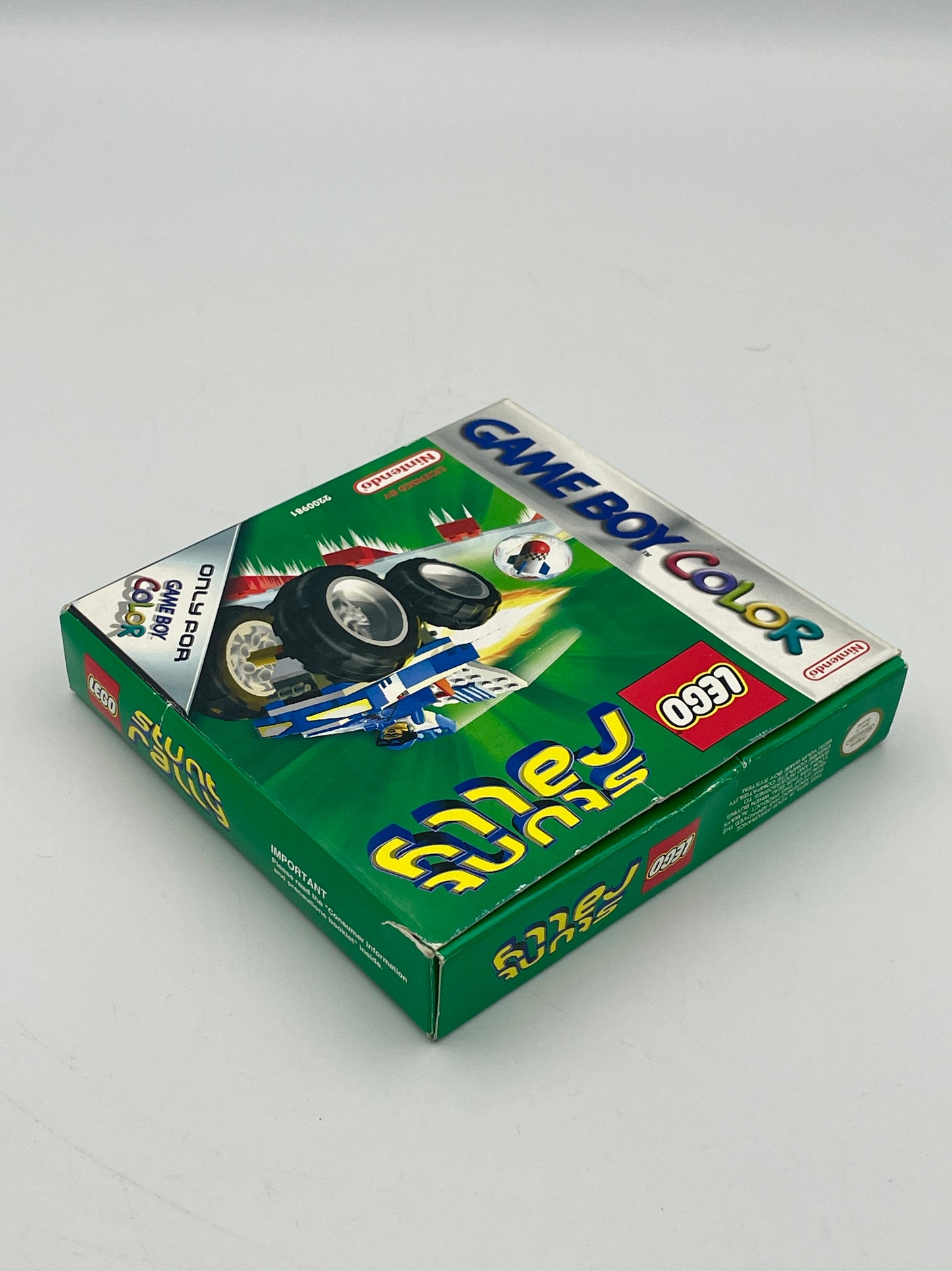 Green Game Boy Color packaging with LEGO branding on a gray background