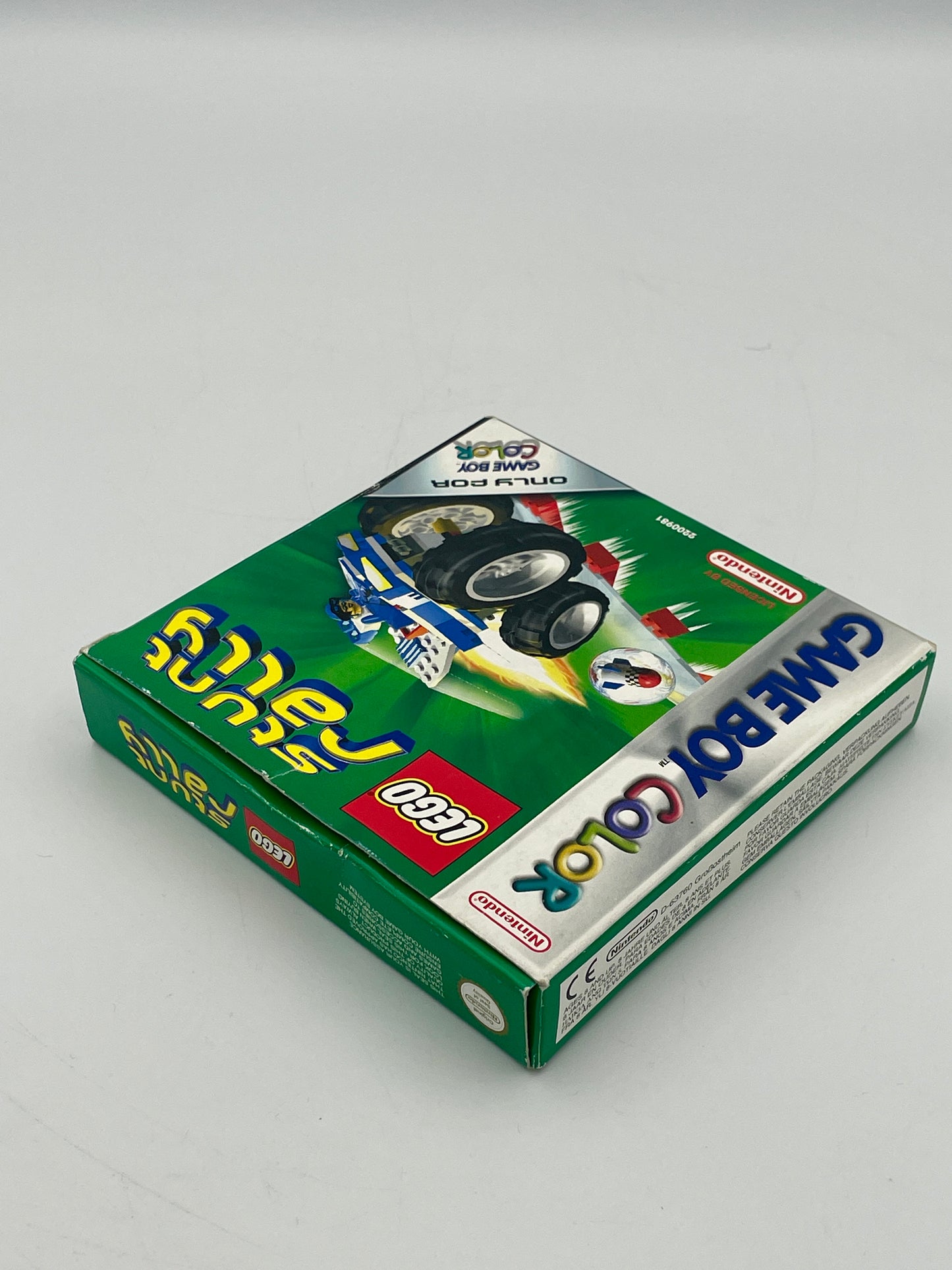 Green Game Boy Color game case with colorful text and branding on a white background