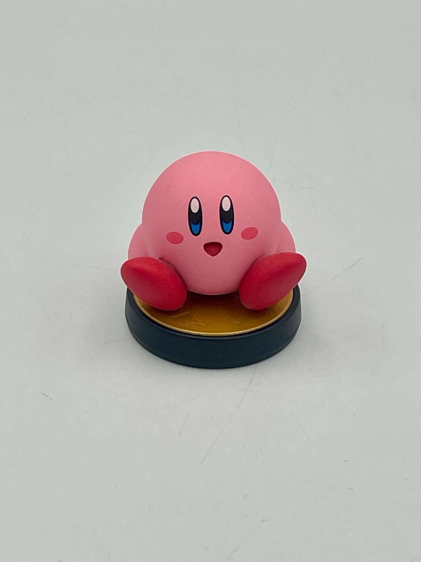 Pink cartoon character figurine on a gray background