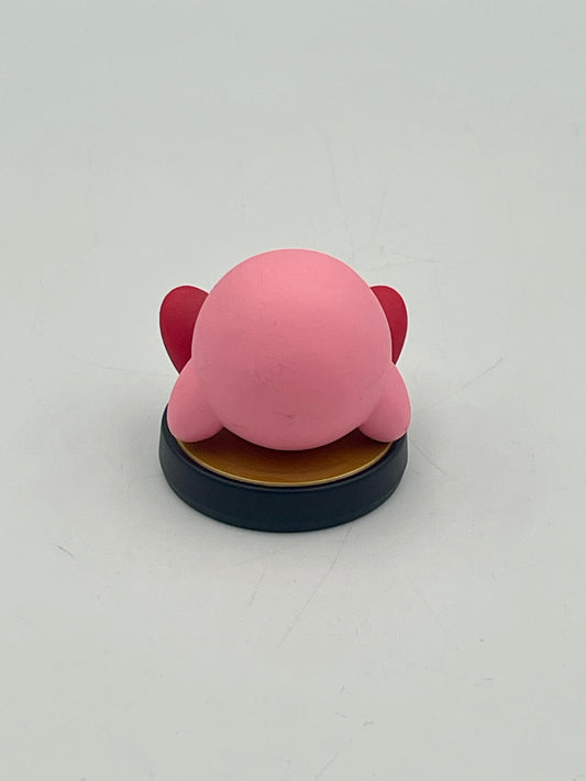 Pink character figurine on a black base against a white background