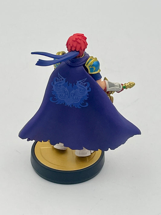 Figurine with a blue cape and red hair on a white background