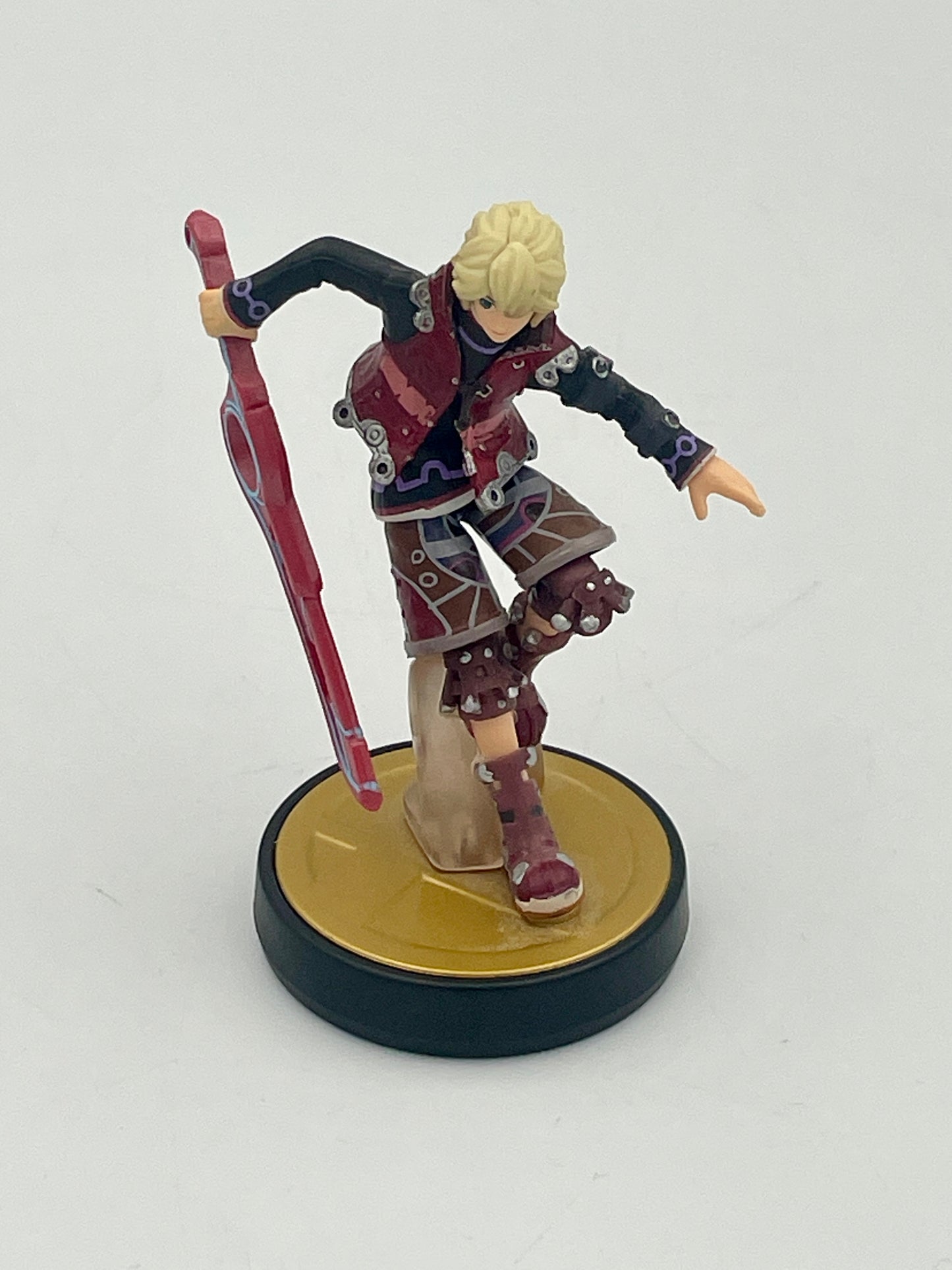 Figurine of a character with a red weapon on a white background
