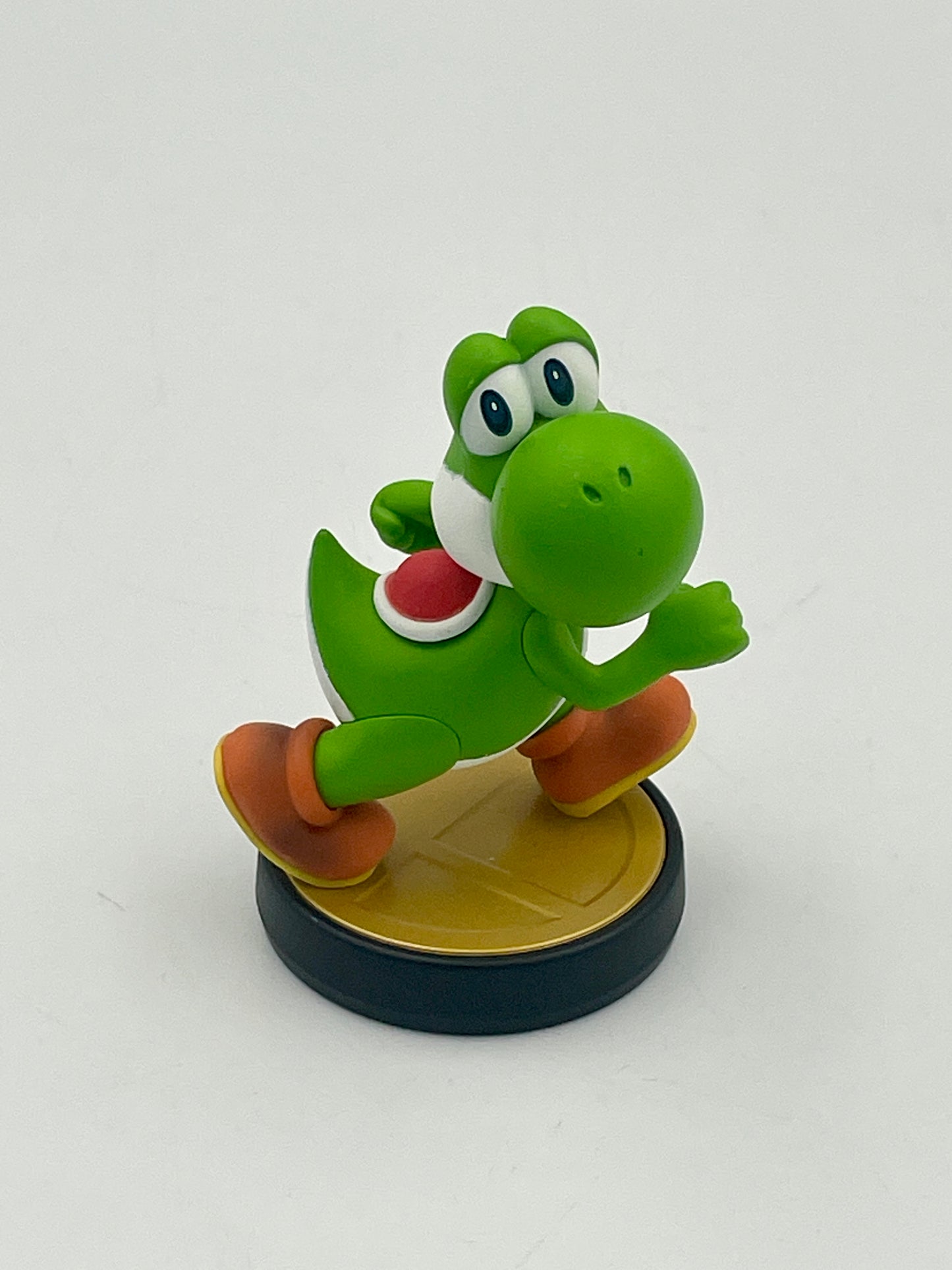 Green dinosaur-like figure with orange shoes on a white background