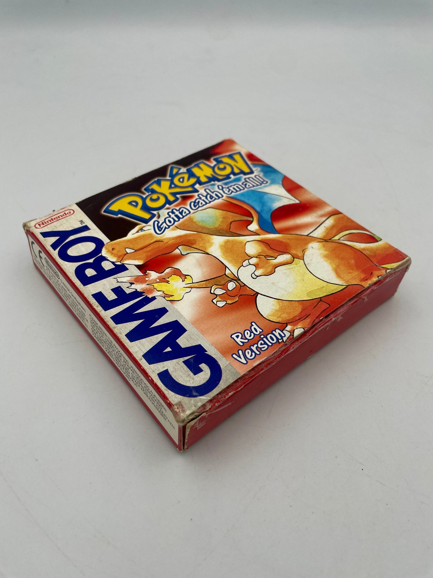 Vintage Pokémon Game Boy Red Version packaging on a white background