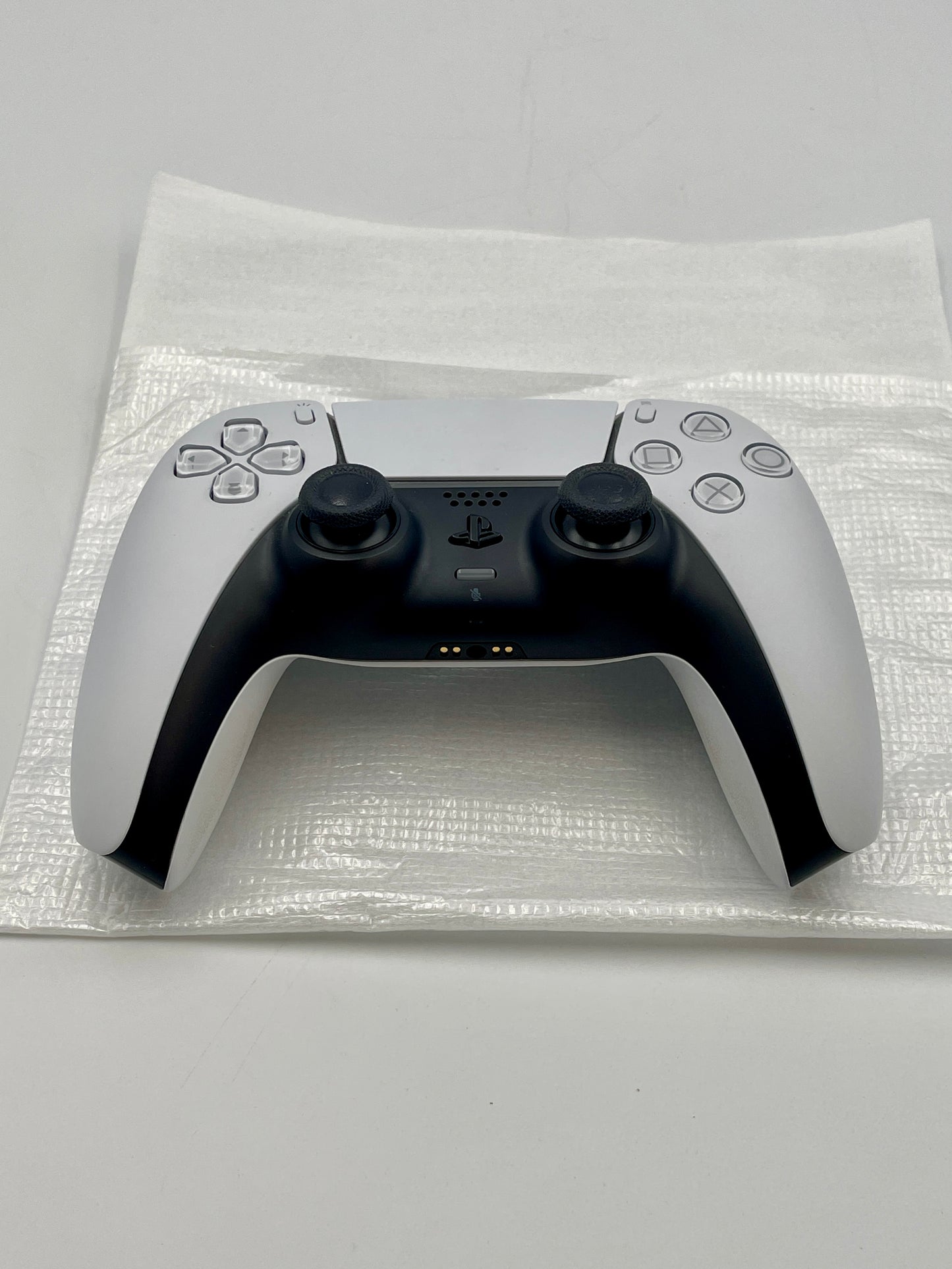 White PS5 Dualsense controller with black accents on a white background