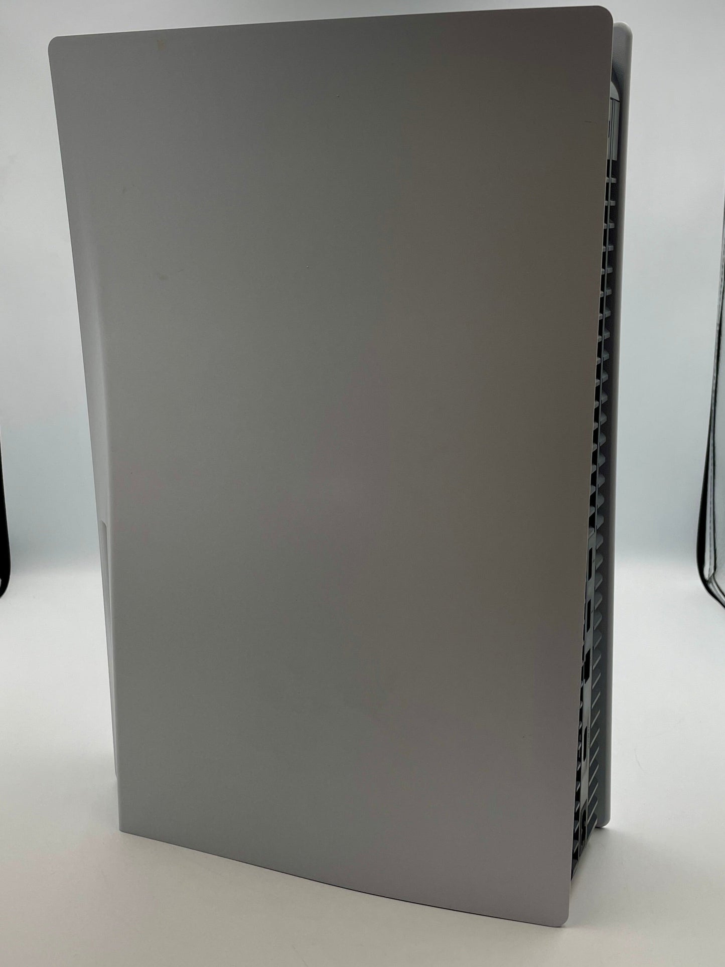 White electronic device on a white surface with a neutral background