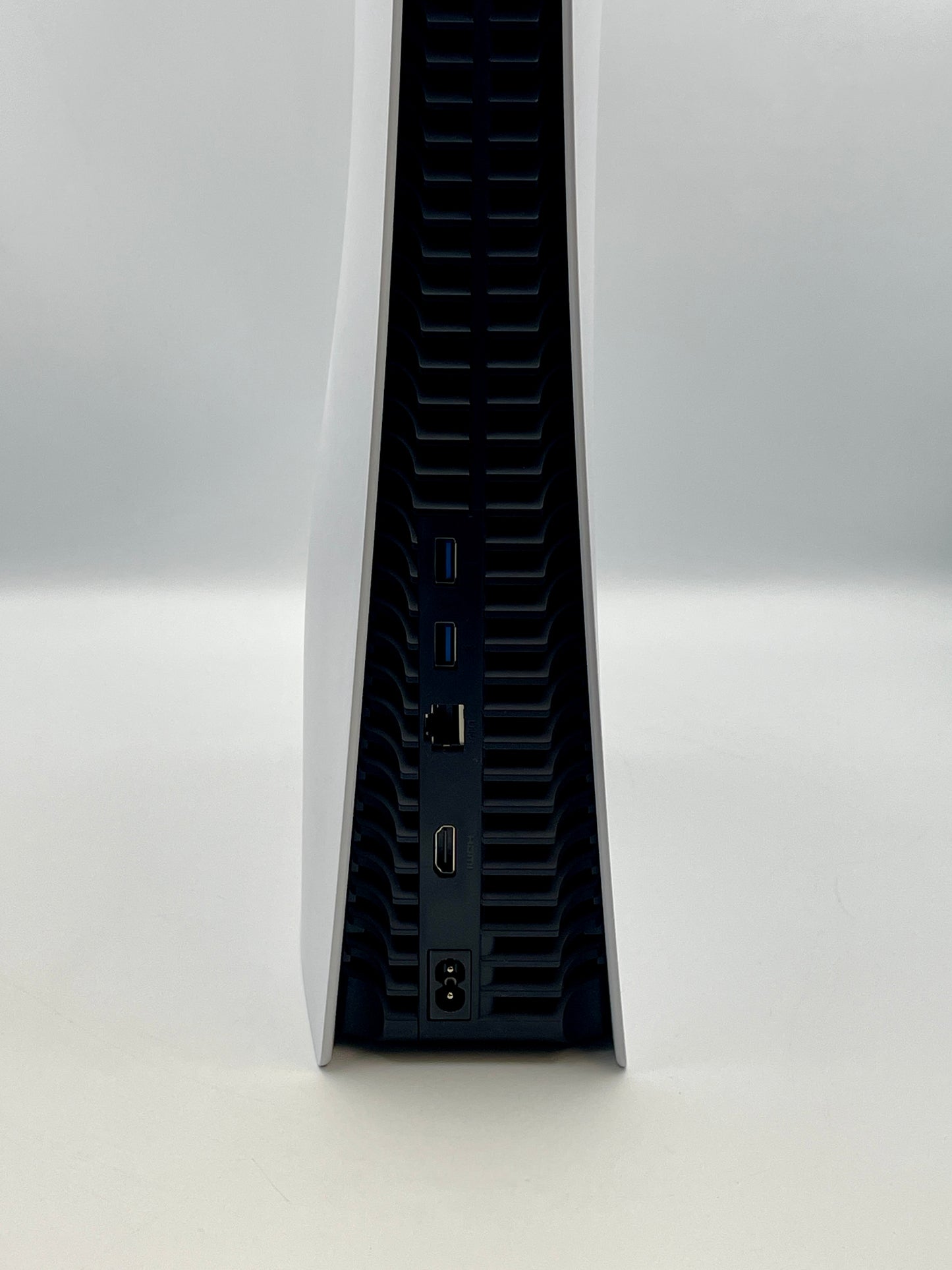 Side view of a PS5 with ports on a white background
