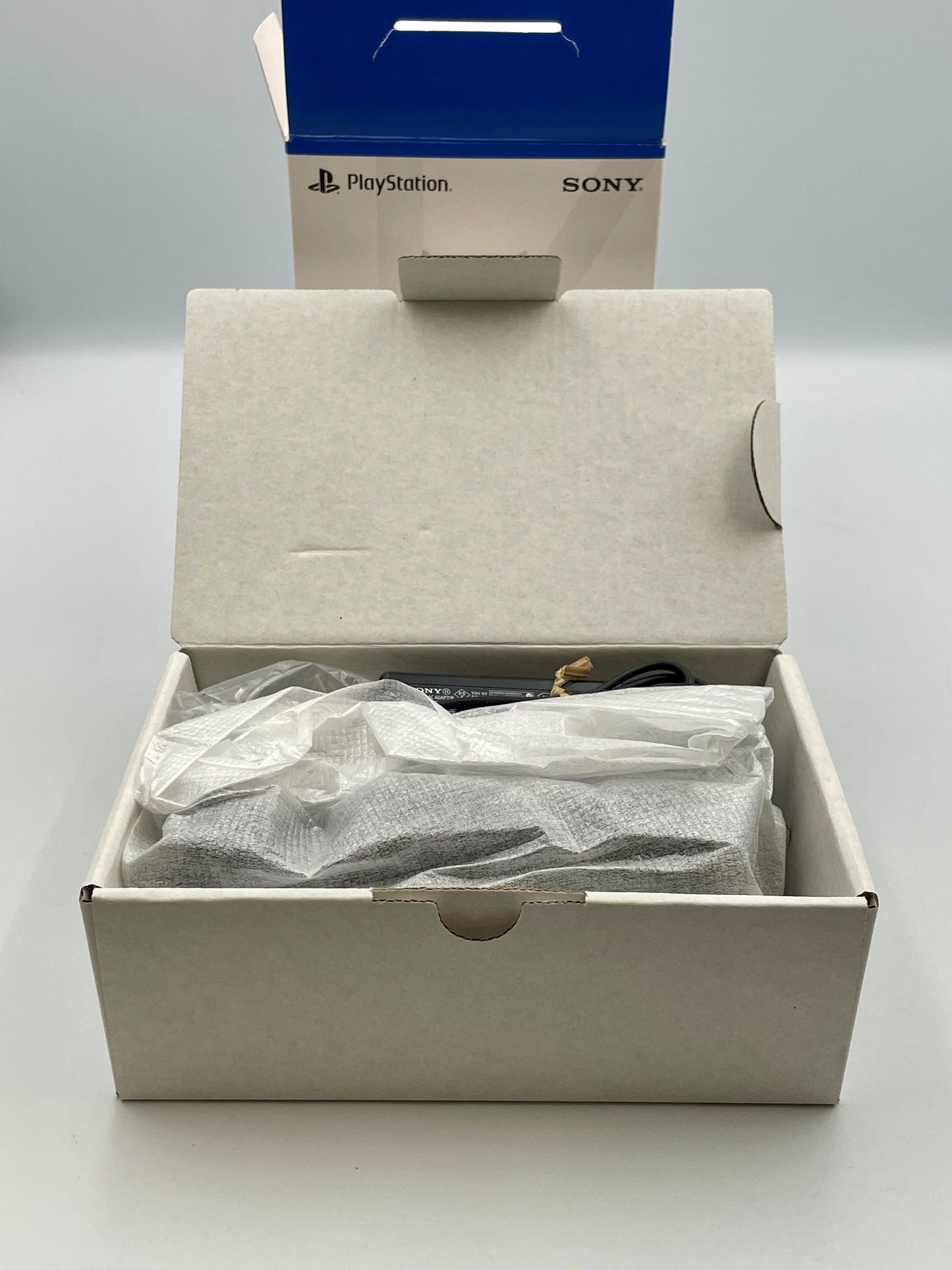Open box containing a PlayStation product with a visible Sony logo.