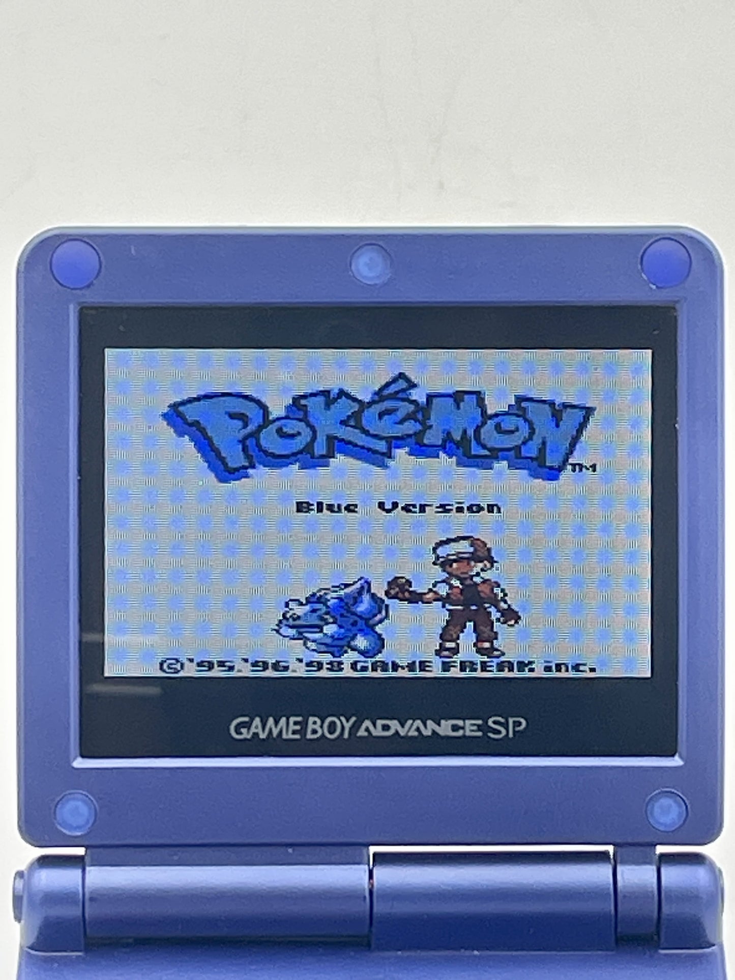 Blue Game Boy Advance SP displaying the 'Pokémon Blue Version' screen.