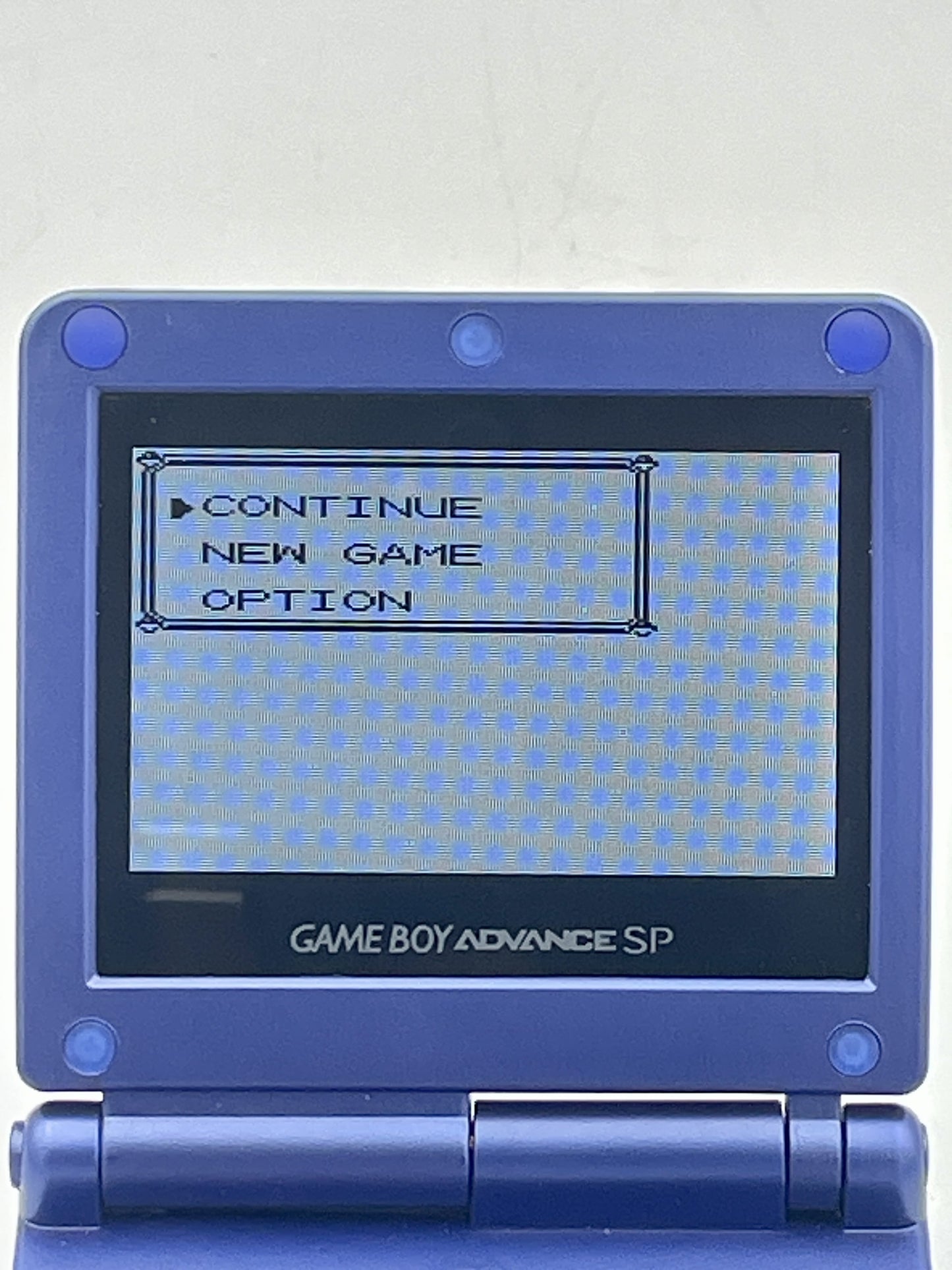 Blue Game Boy Advance SP with a menu displayed on the screen