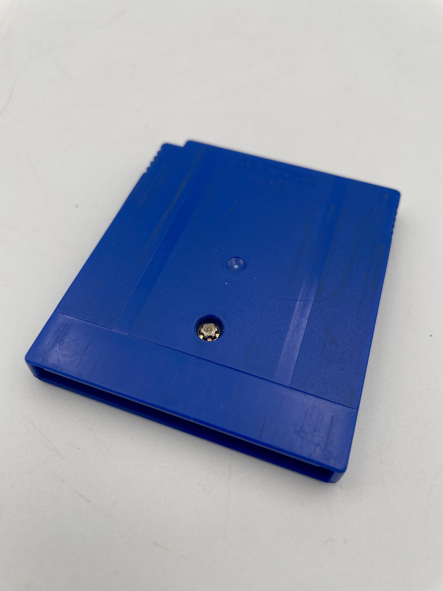 Blue plastic cover with a central screw on a white background