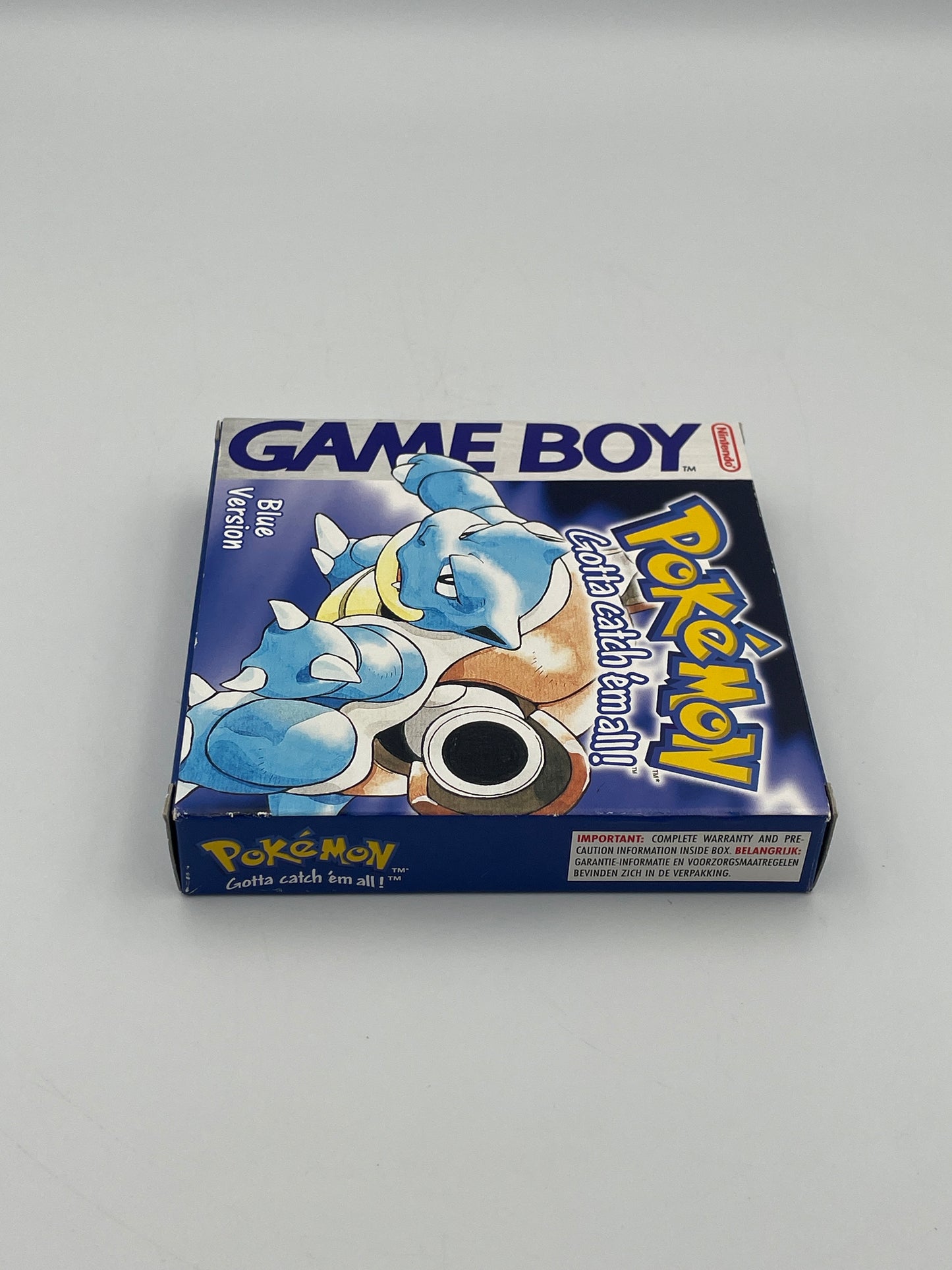 Pokémon Game Boy Blue Version packaging on a gray background