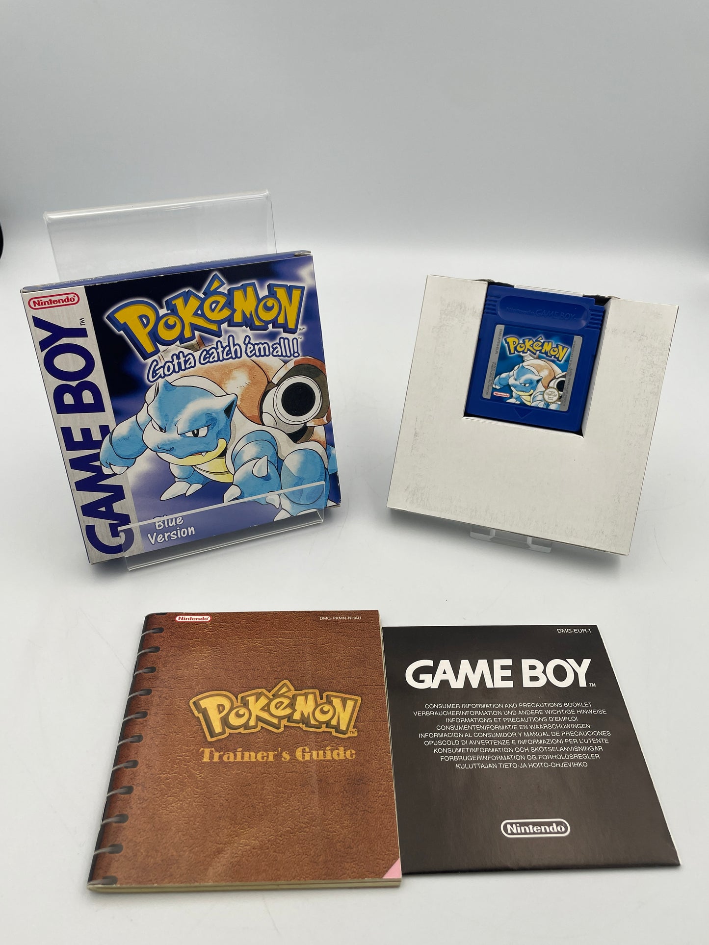 Four Game Boy cartridges and manuals on a white background