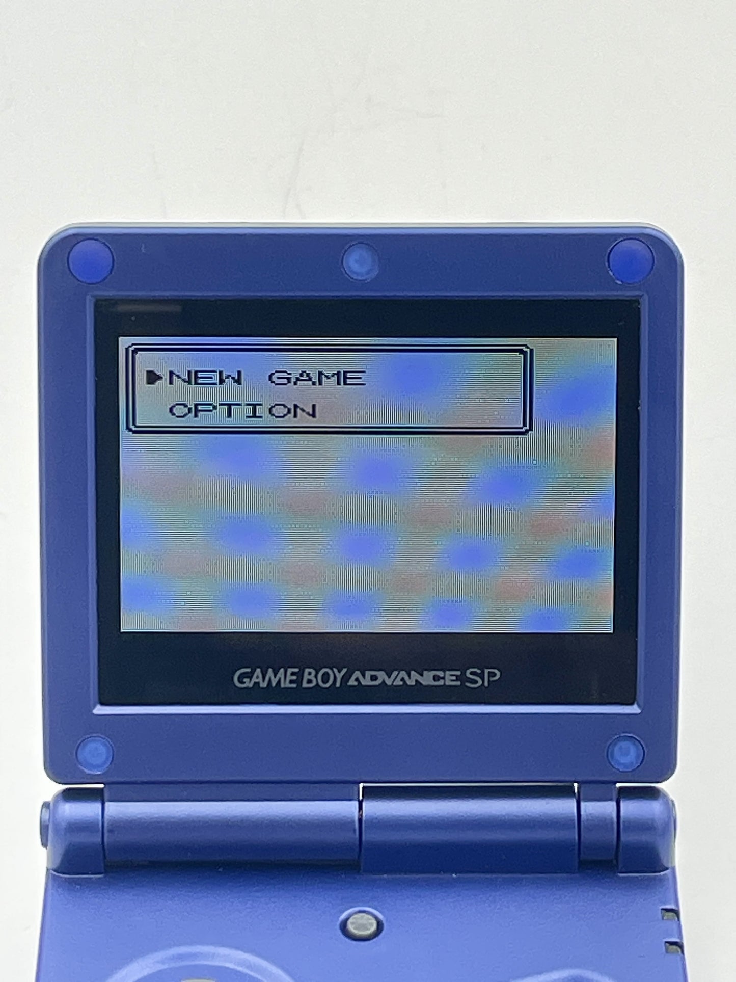 Blue Game Boy Advance SP with screen displaying game menu on a white background