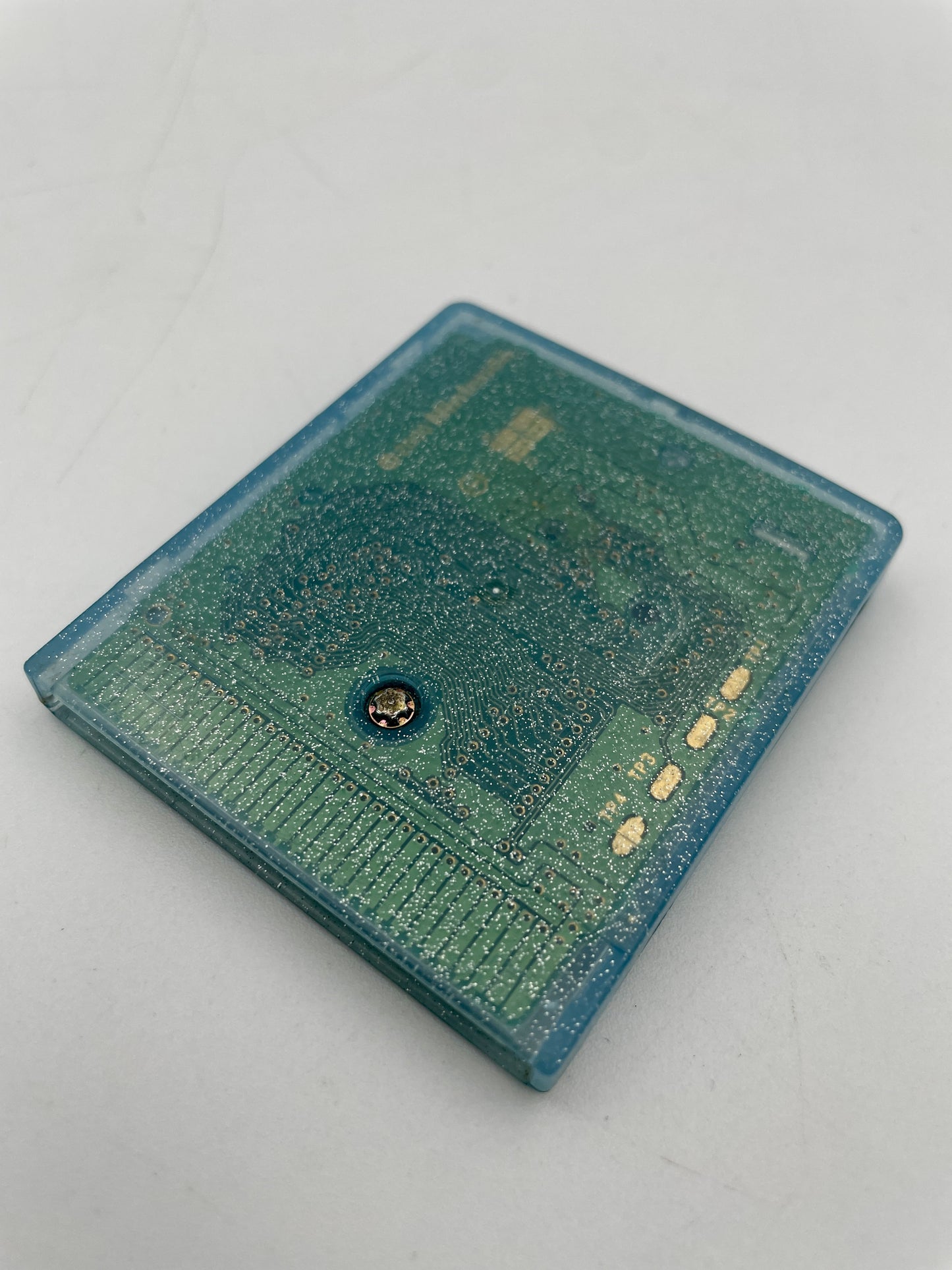 Close-up of a green circuit board on a white background