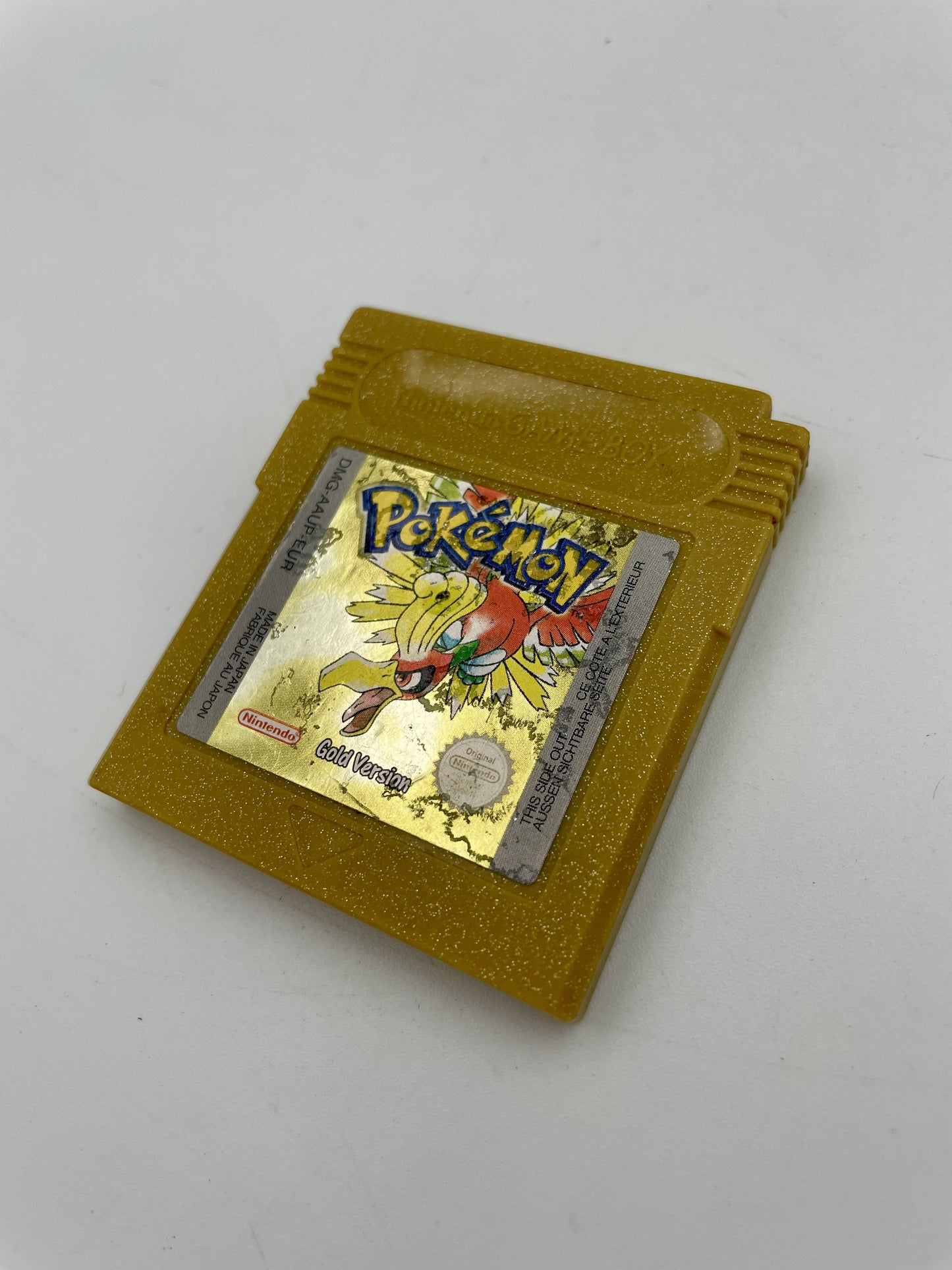 Gold Game Boy cartridge with Pokémon design on a white background