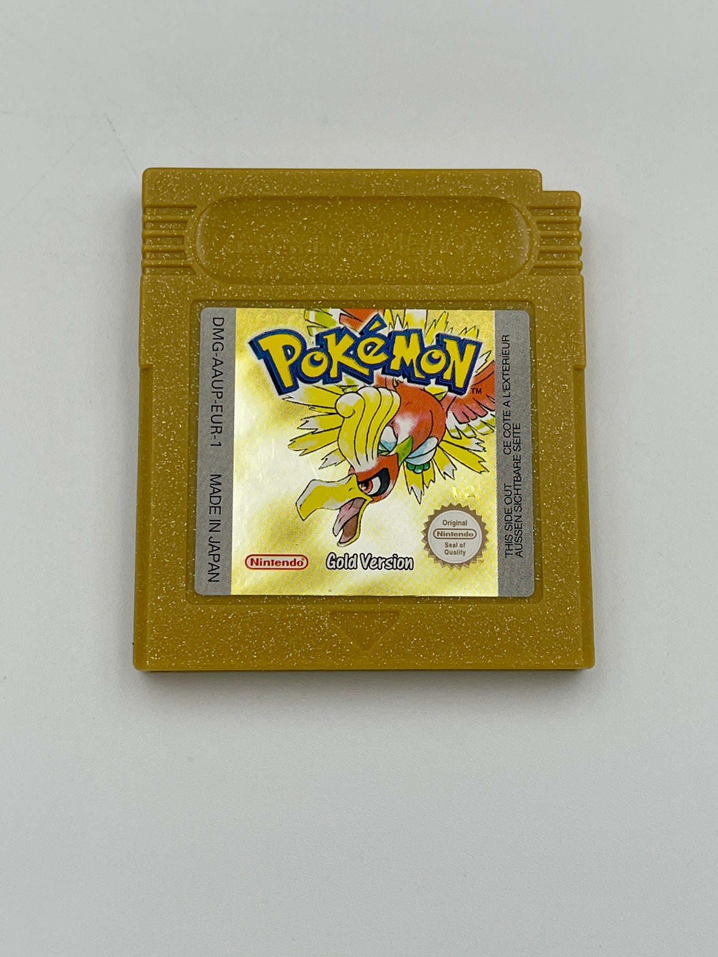 Gold Game Boy cartridge of 'Pokémon Gold Version' on a white background