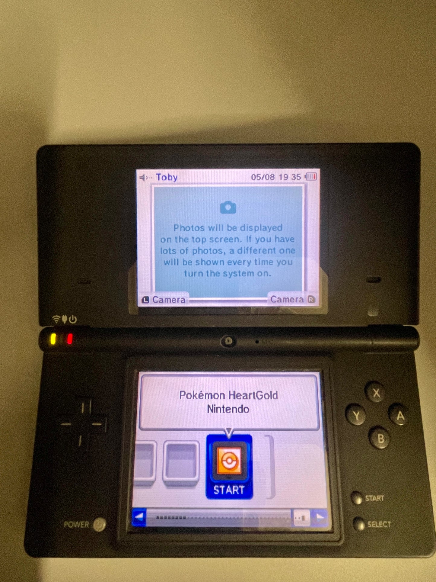 Nintendo DS gaming console with a screen displaying a game menu.