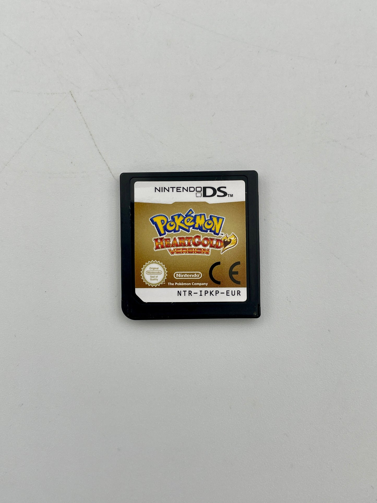 Nintendo DS game cartridge with 'Pokémon HeartGold' on a gray background
