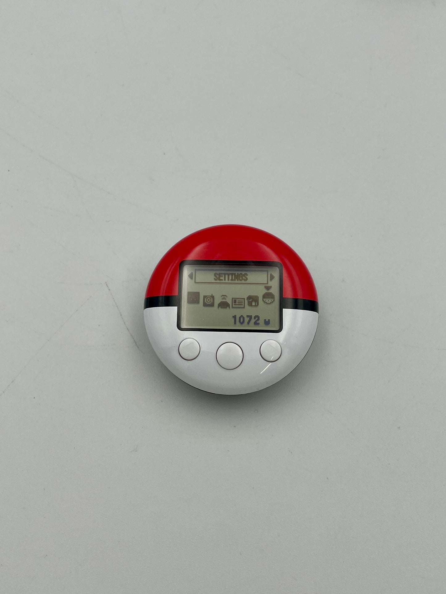 Red and white electronic device on a gray background
