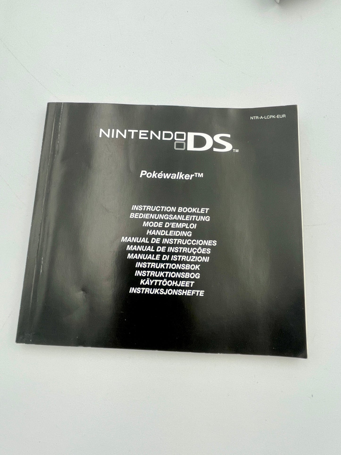 Black Nintendo DS Pokéwalker instruction booklet on a white background