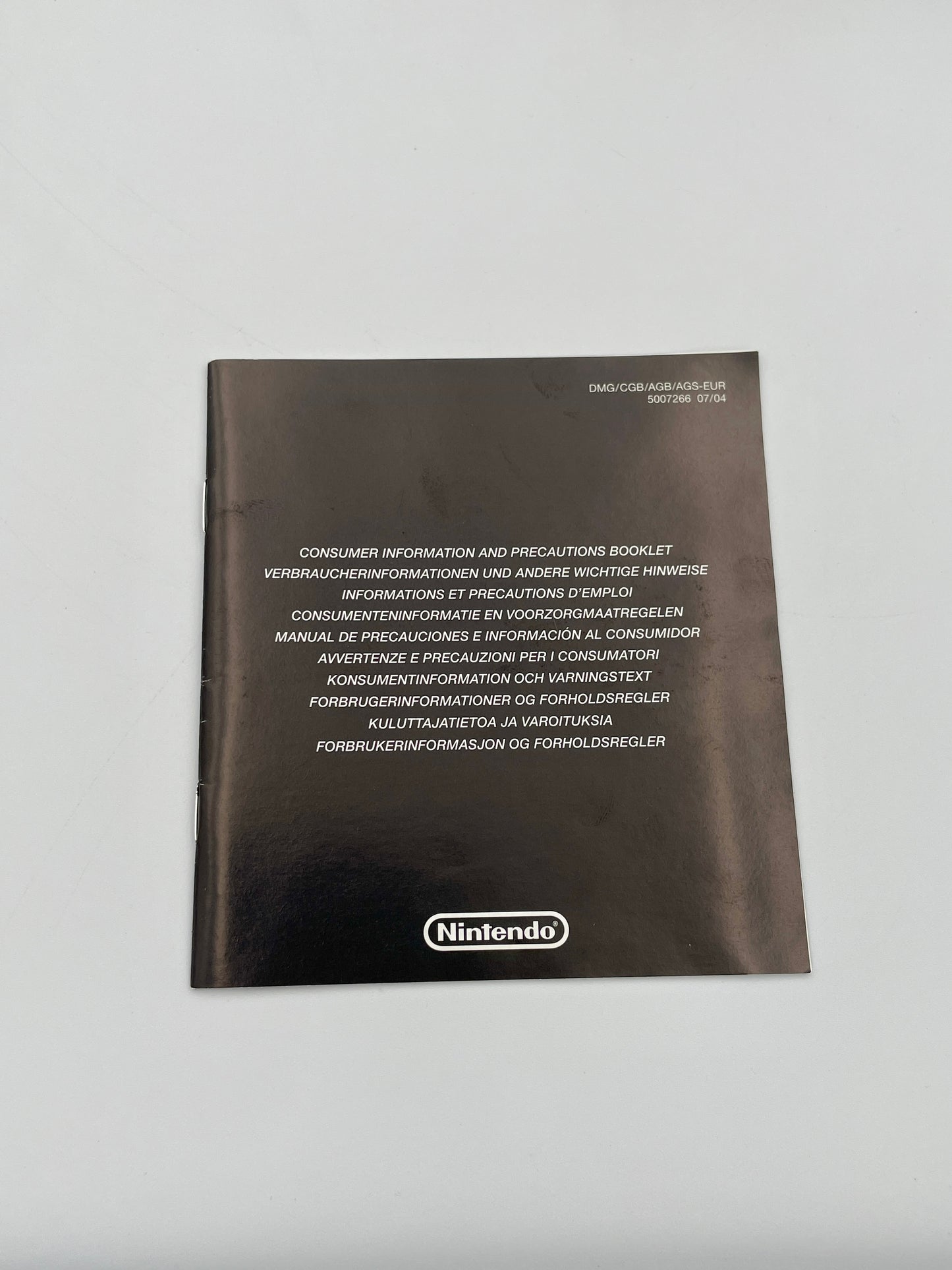 Nintendo consumer information booklet on a gray background