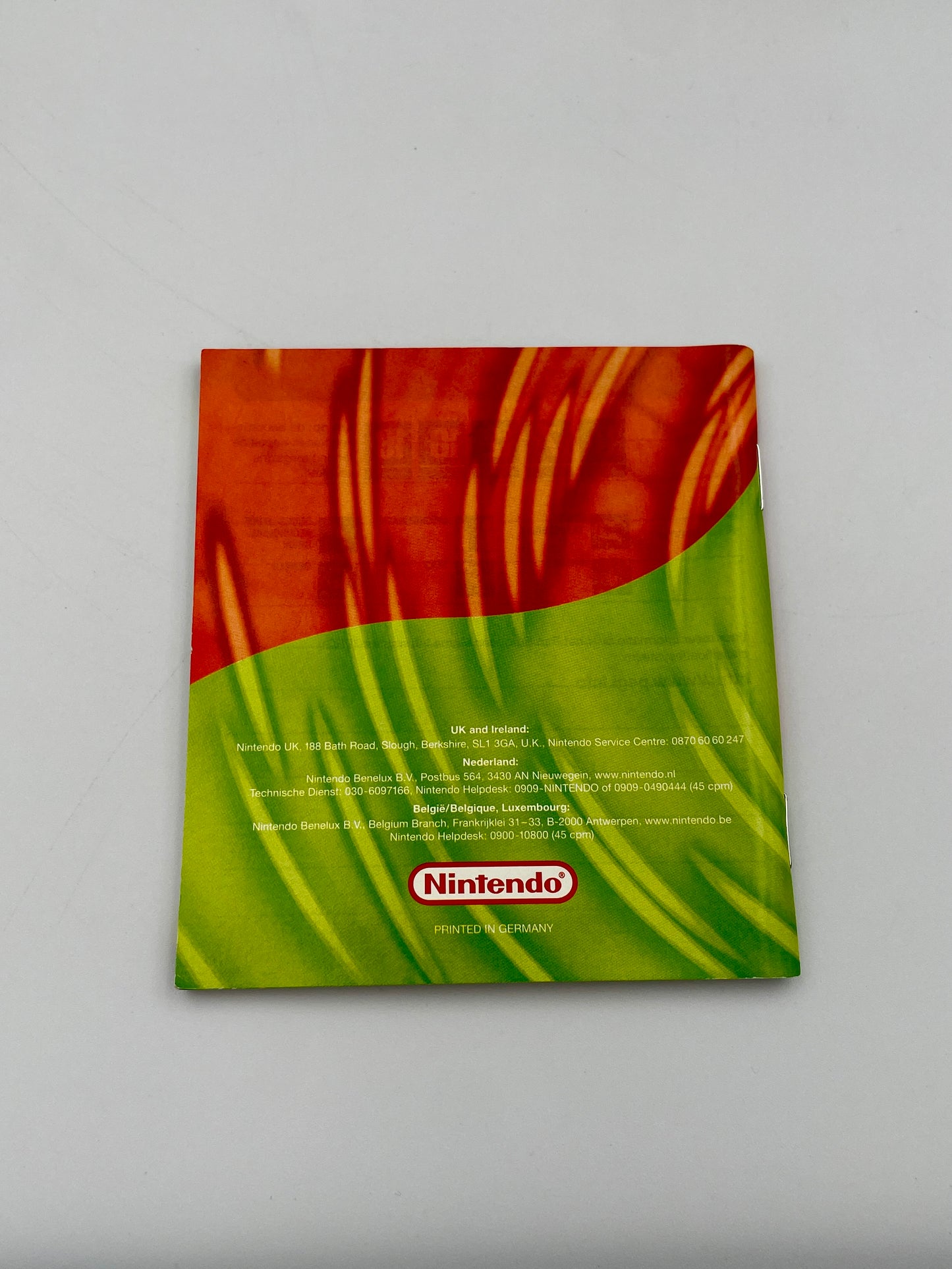 Nintendo product packaging with red and green design on a gray background