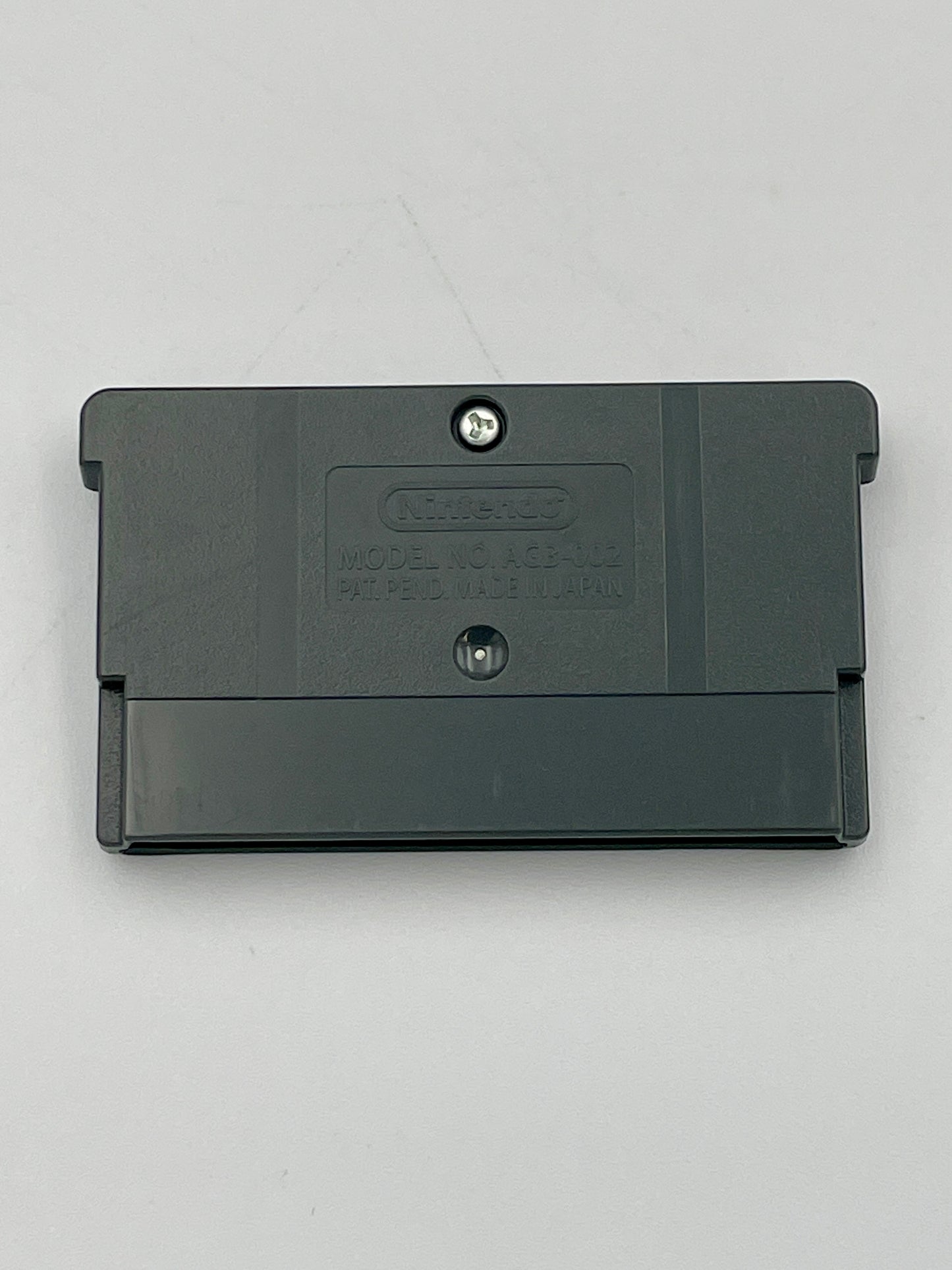 Black game cartridge on a light gray background