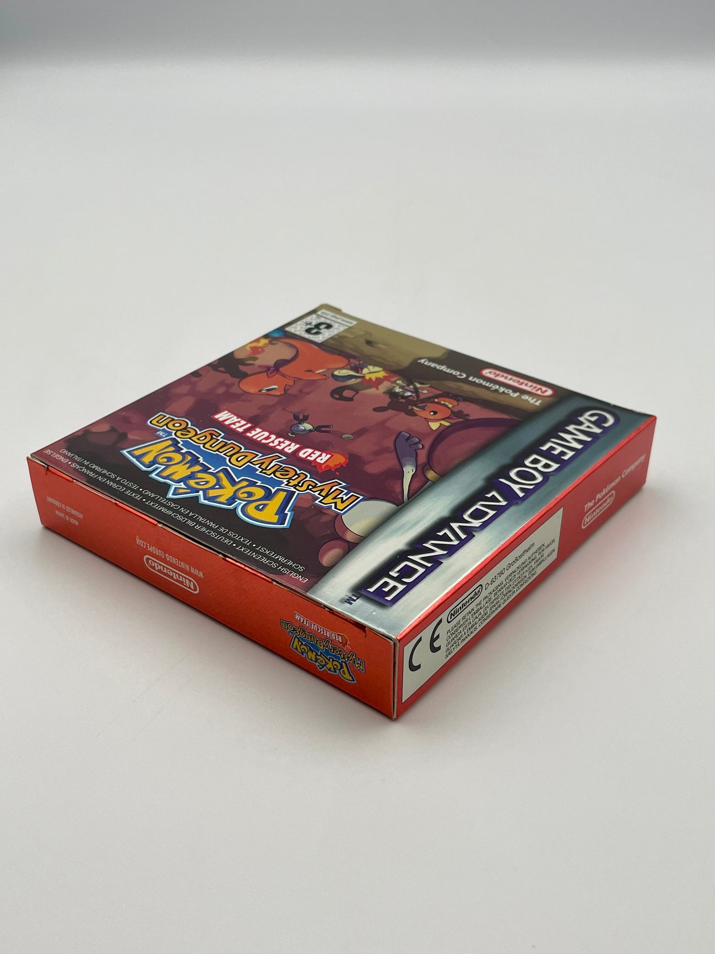 Game Boy Advance game case with 'Pokémon Red' branding on a white background