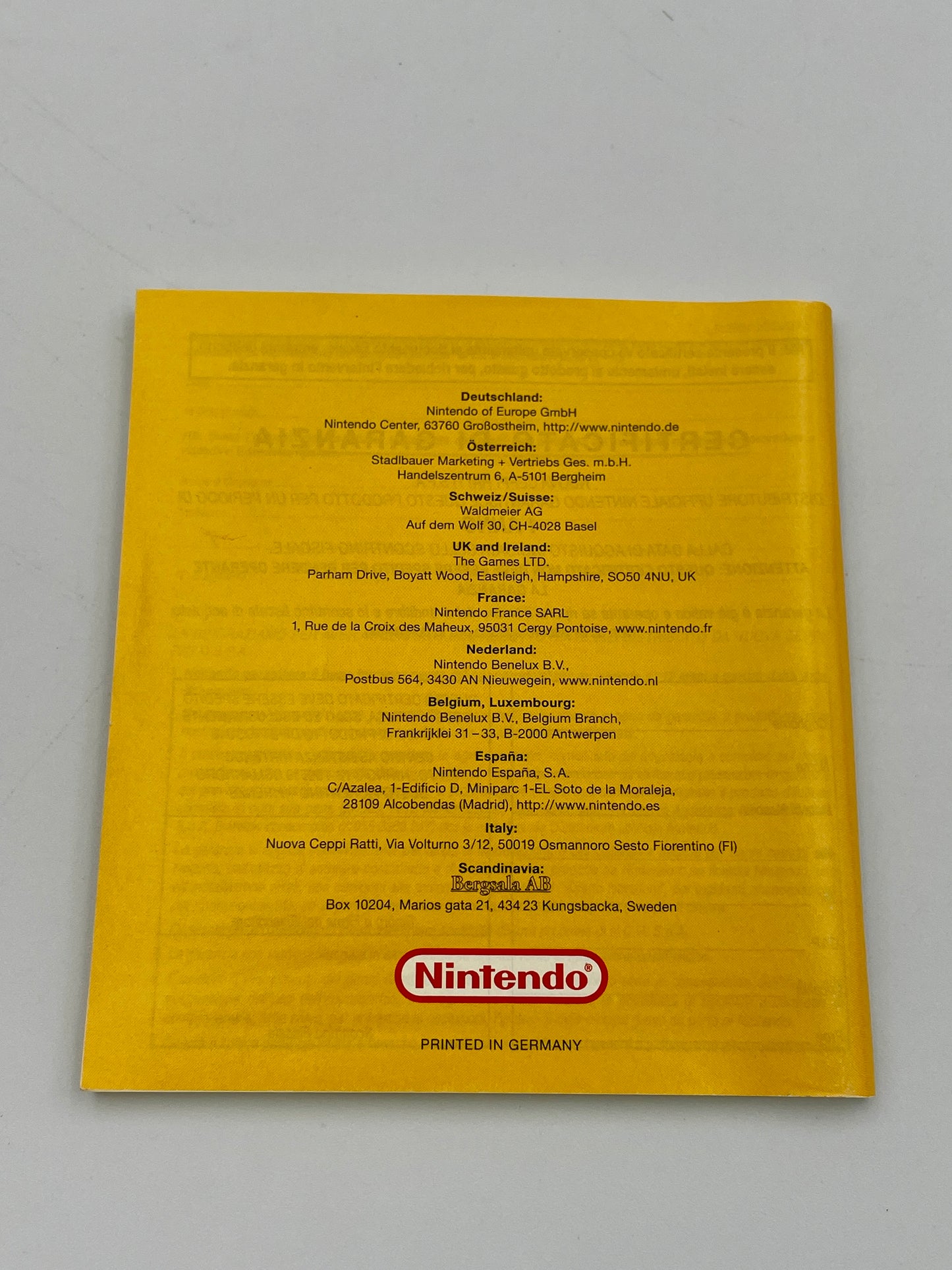 Yellow Nintendo product packaging with text and logo on a gray background