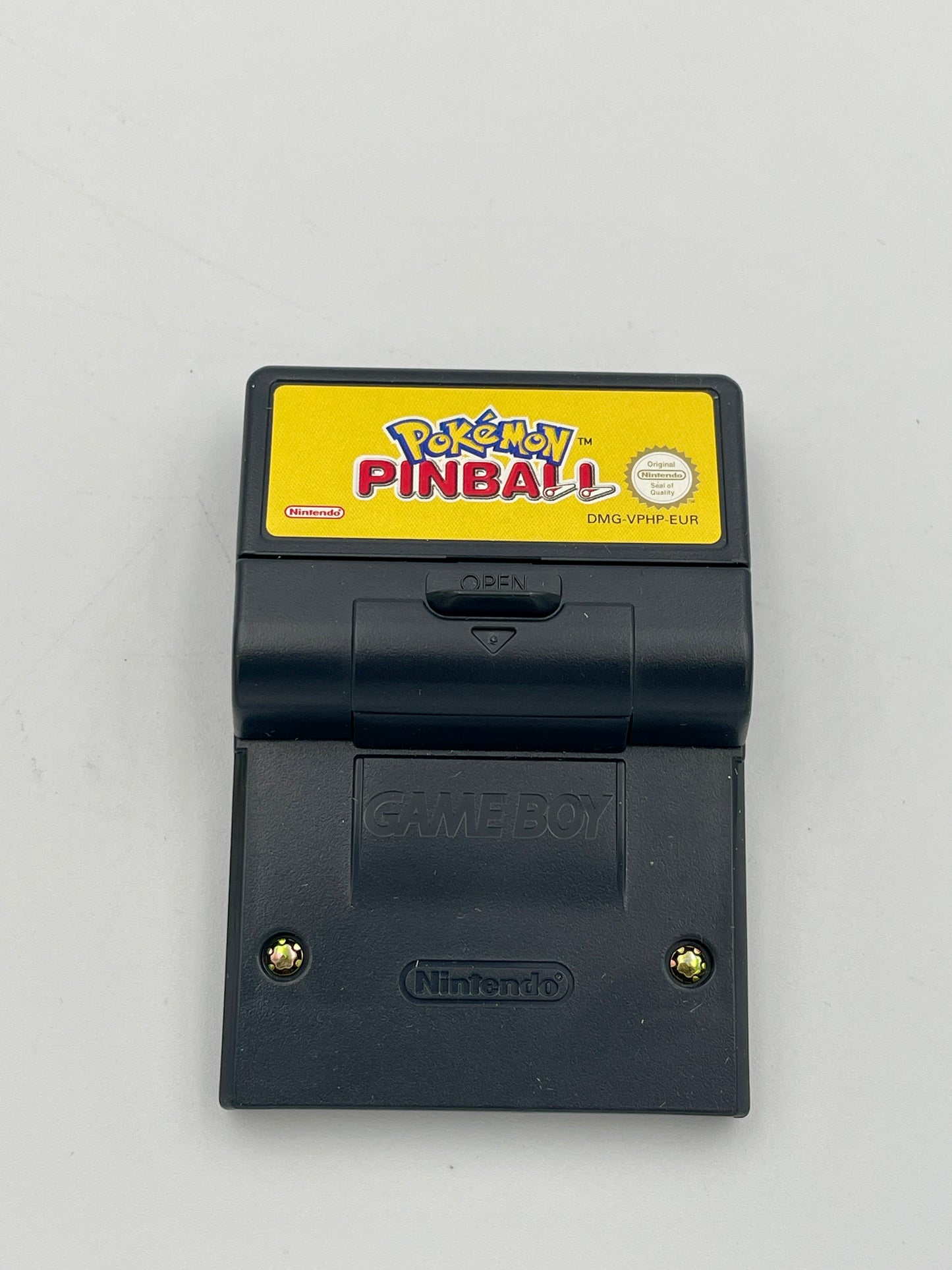 Nintendo Game Boy with a Pokémon Pinball cartridge on a gray background