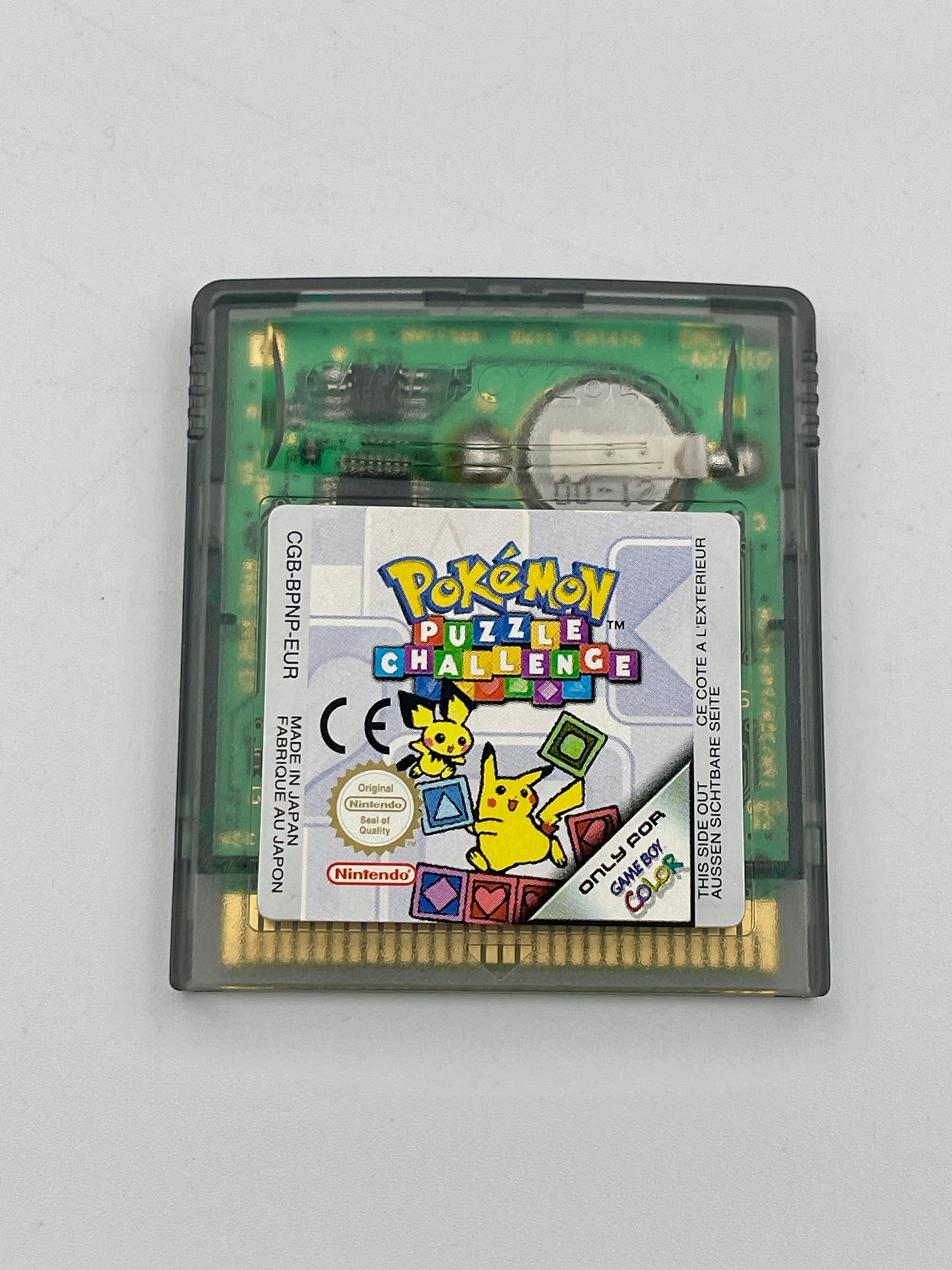 Pokémon Puzzle Challenge game cartridge on a light gray background