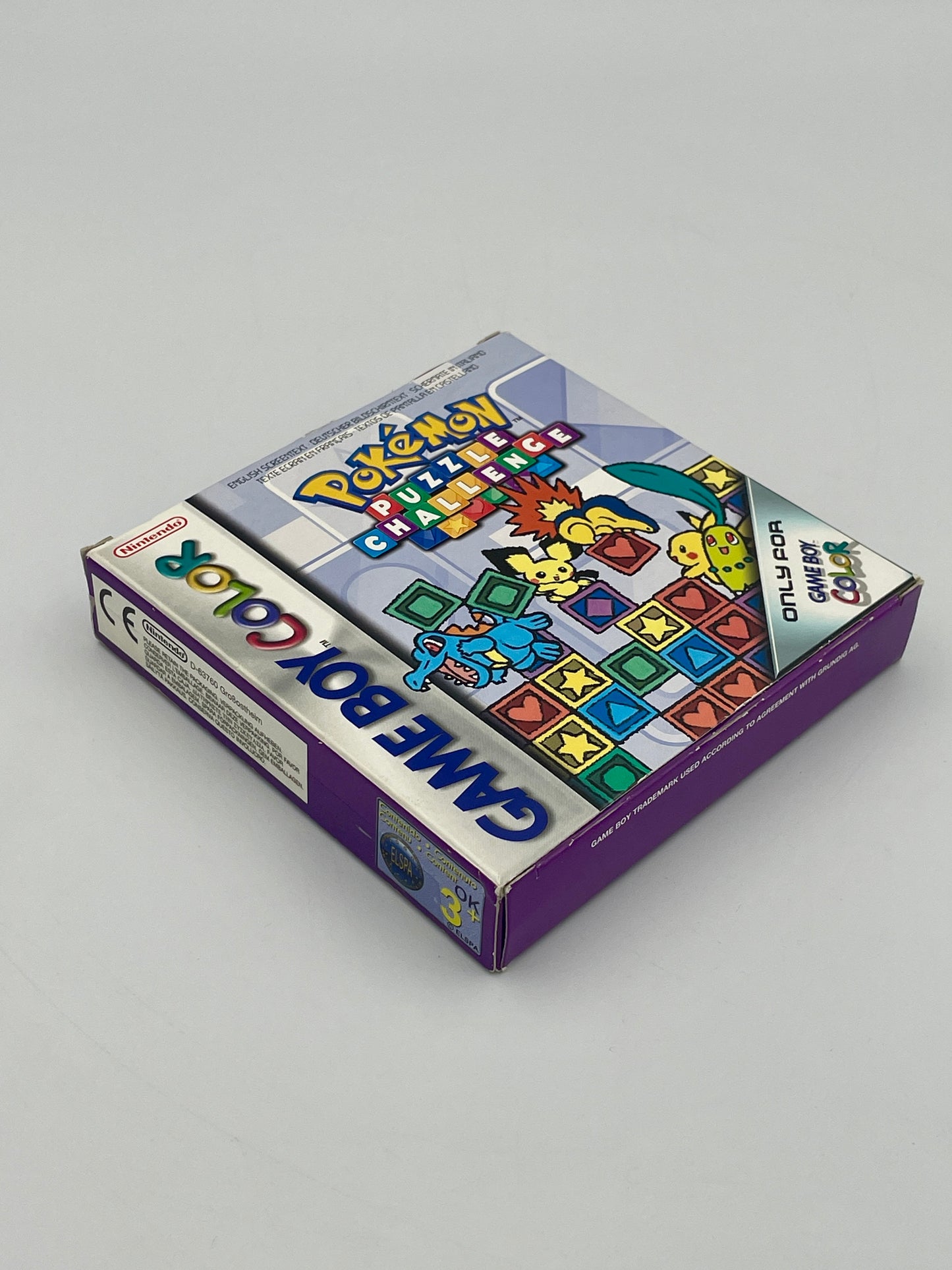 Vintage Game Boy Color packaging with colorful graphics on a gray background