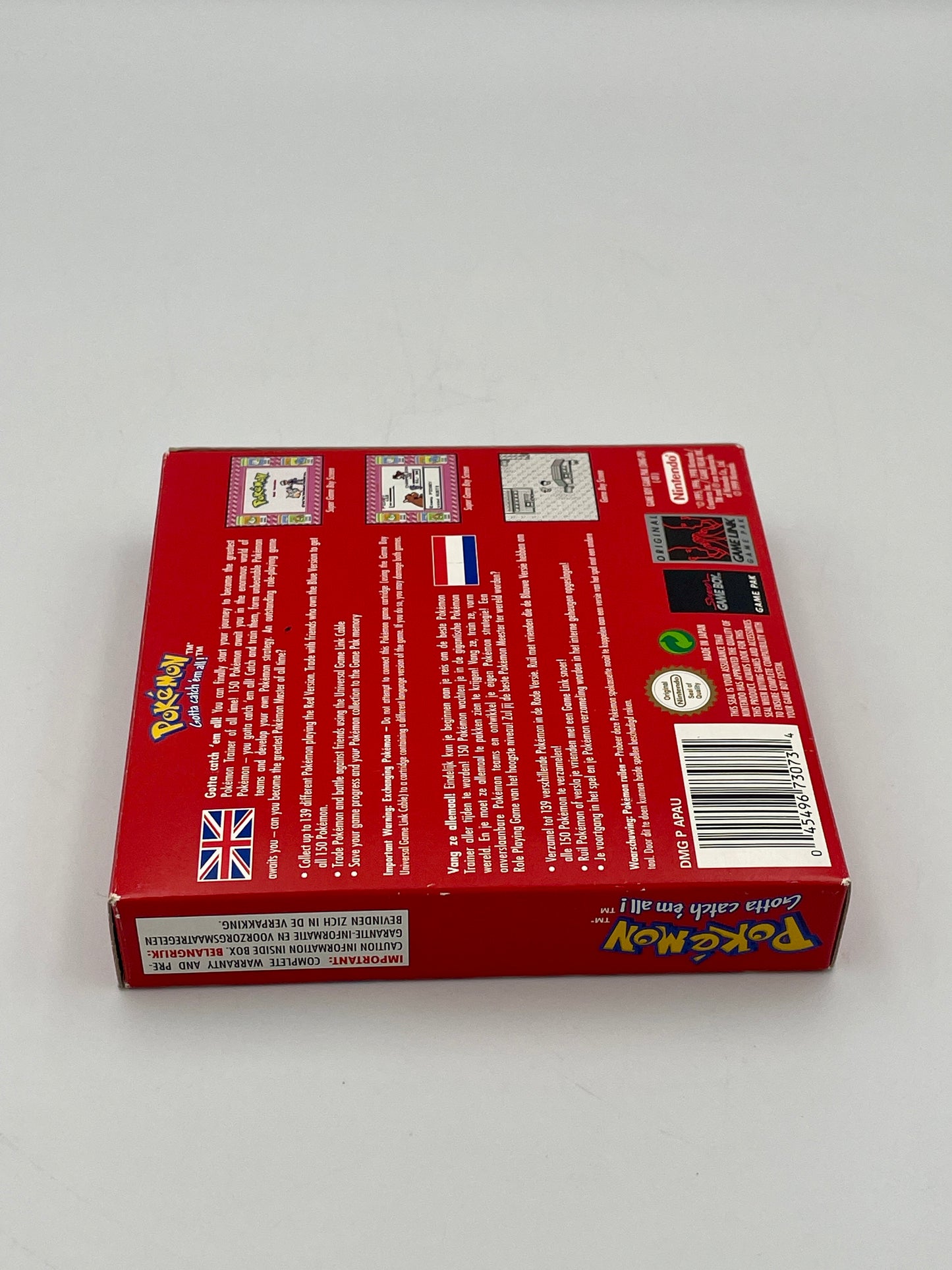 Back view of a red trading card game box with text and logos on a white background