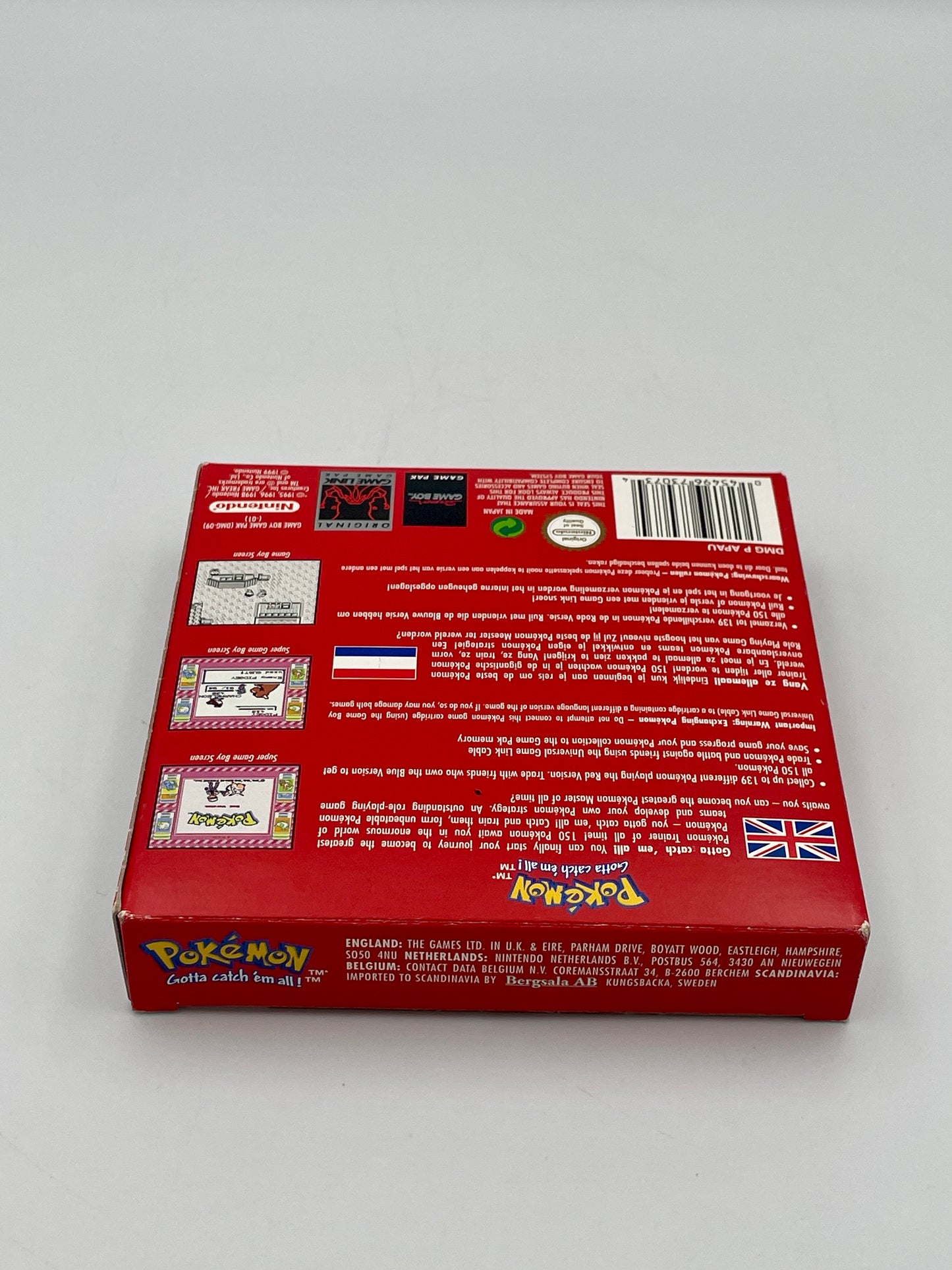 Back view of a red Pokémon trading card game box on a gray background