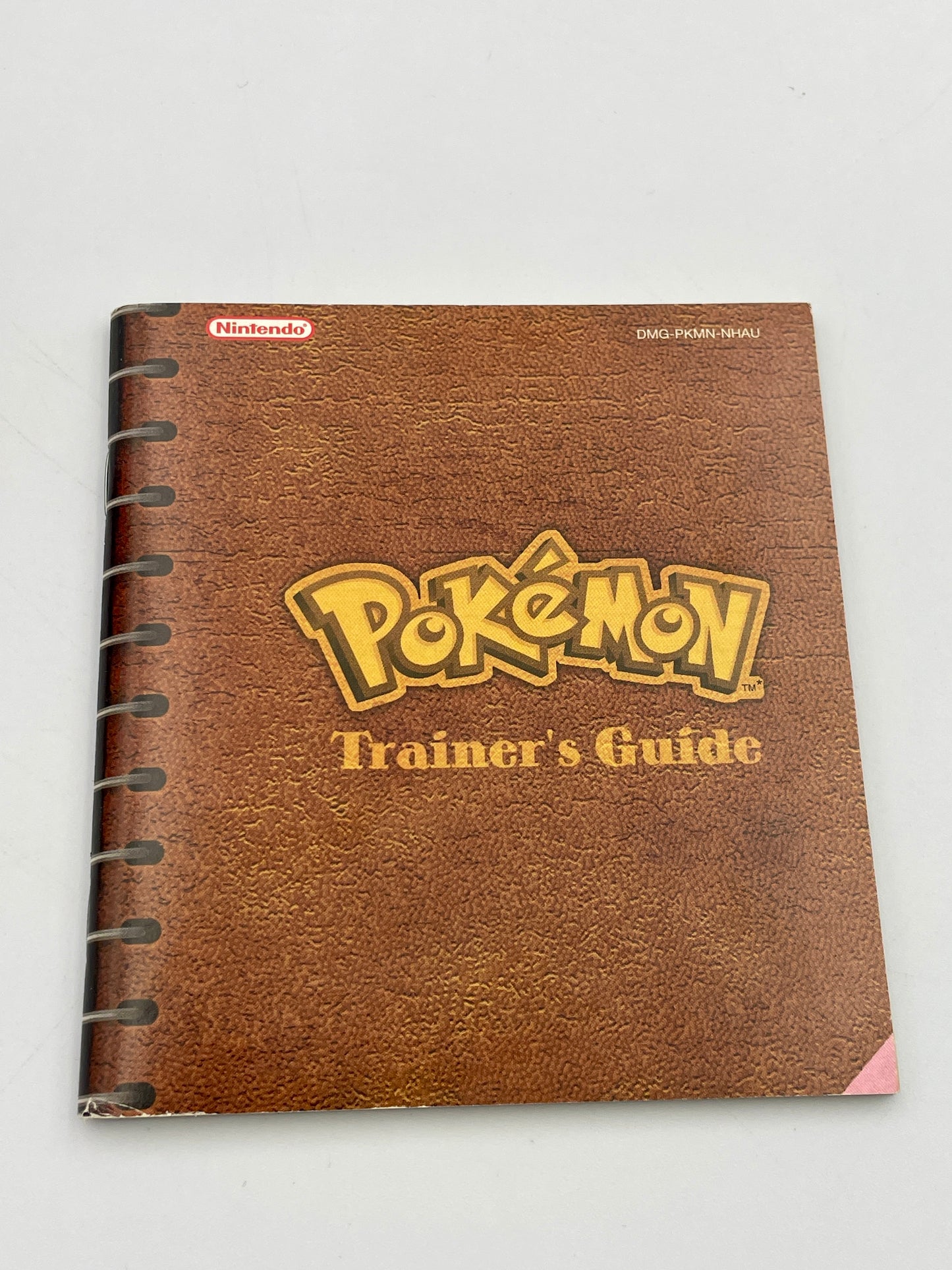 Brown notebook with 'Pokémon Trainer's Guide' on a white background