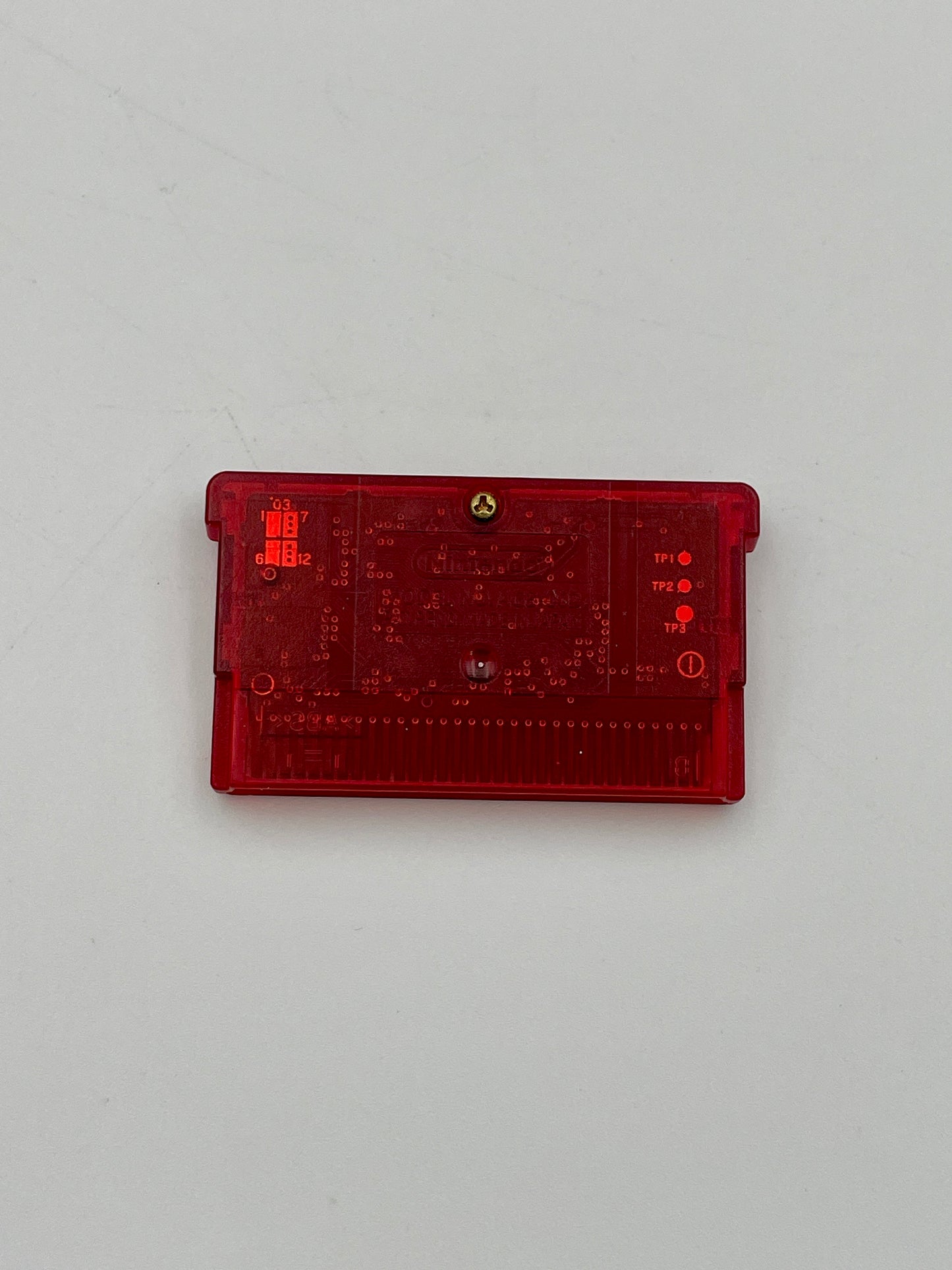 Red rectangular electronic component on a light gray background