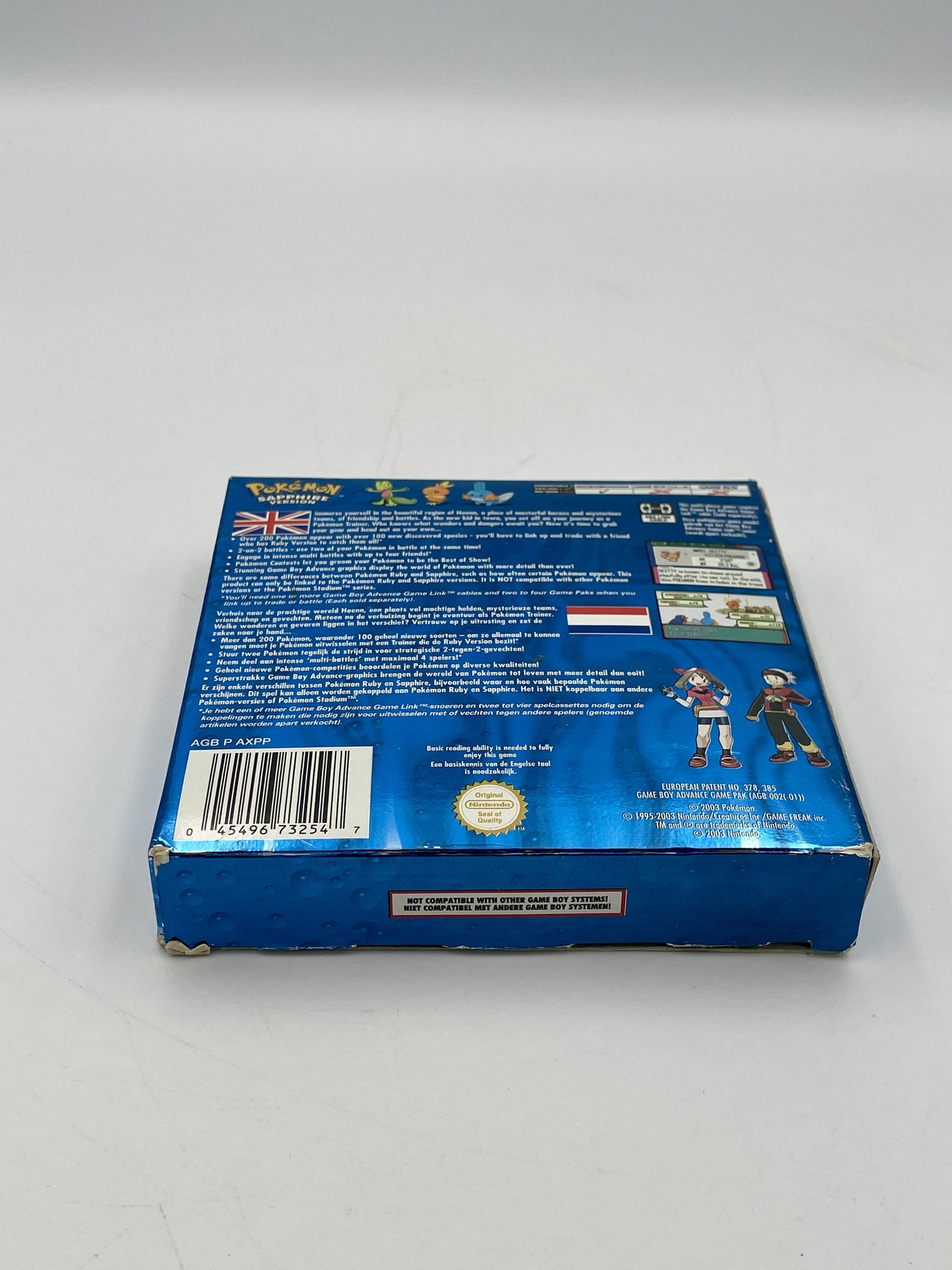 Back view of a blue box with text and graphics on a white background