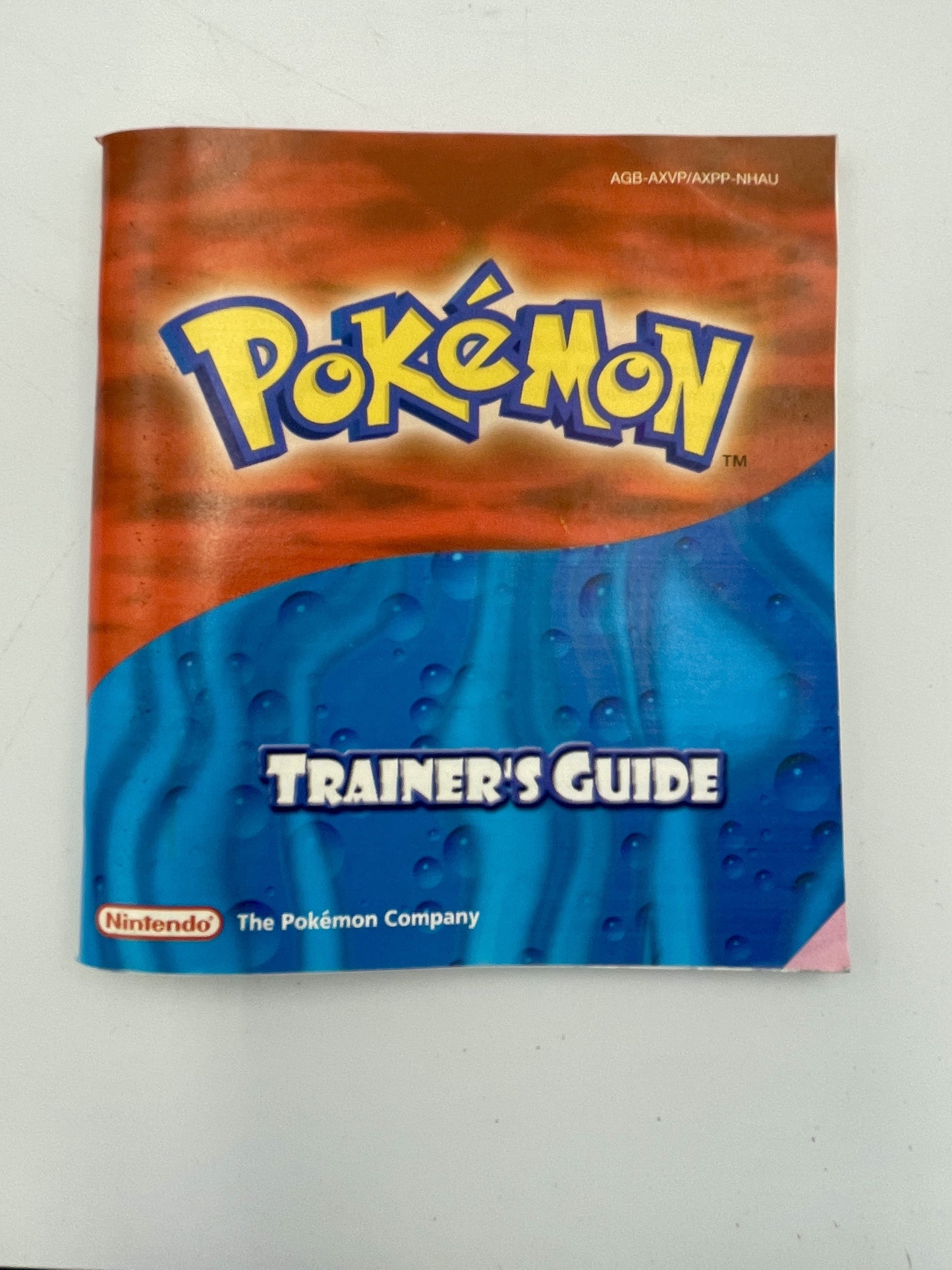 Pokémon Trainer's Guide book with Pokémon logo on a white background