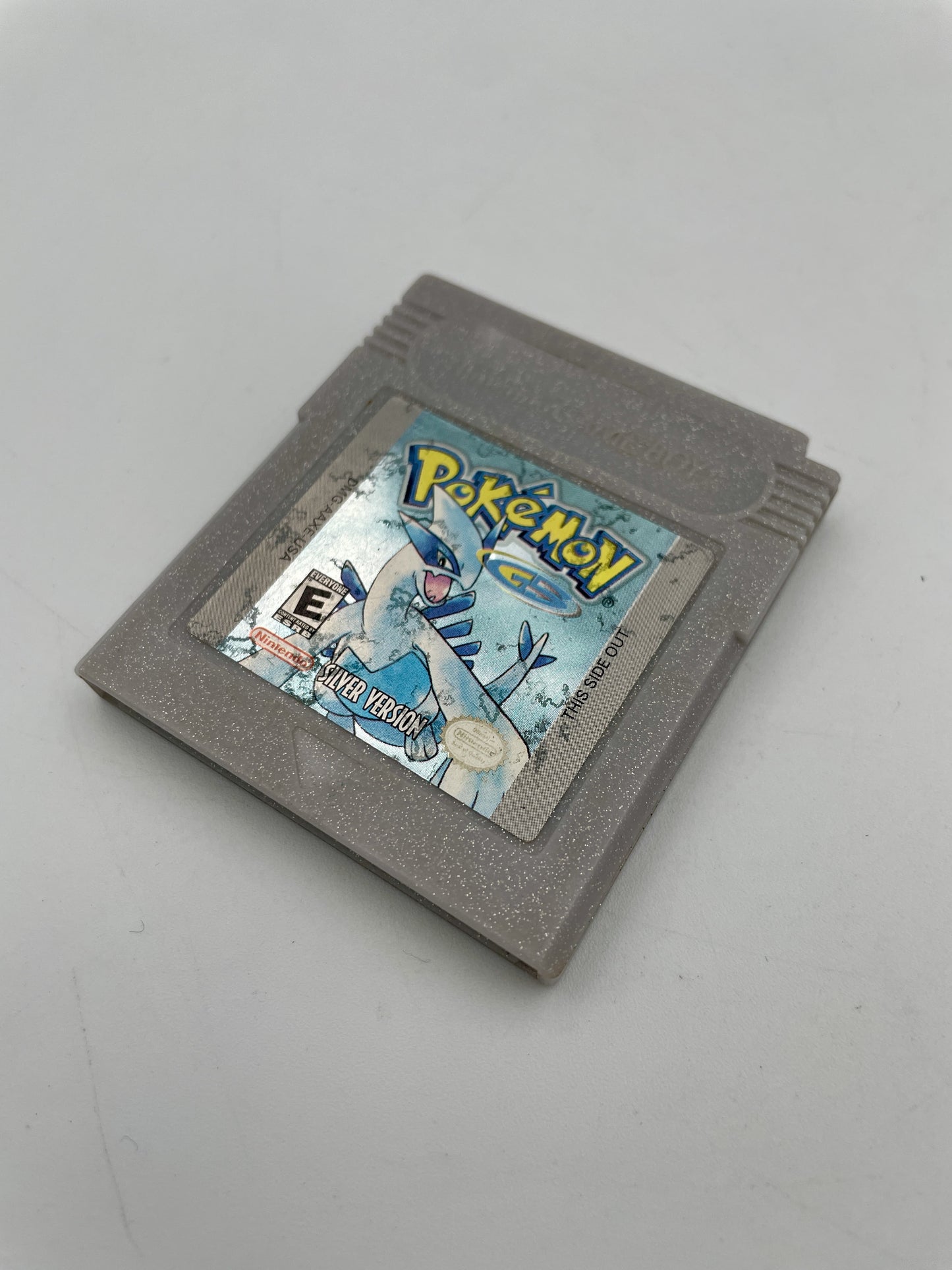 Gray game cartridge with 'Pokémon' branding on a gray background
