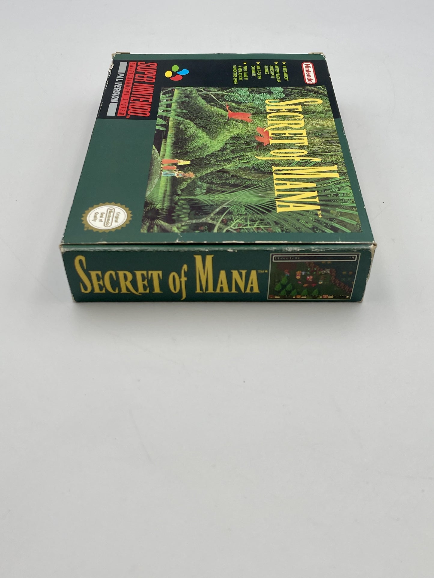 Box of 'Secret of Mana' game on a gray background