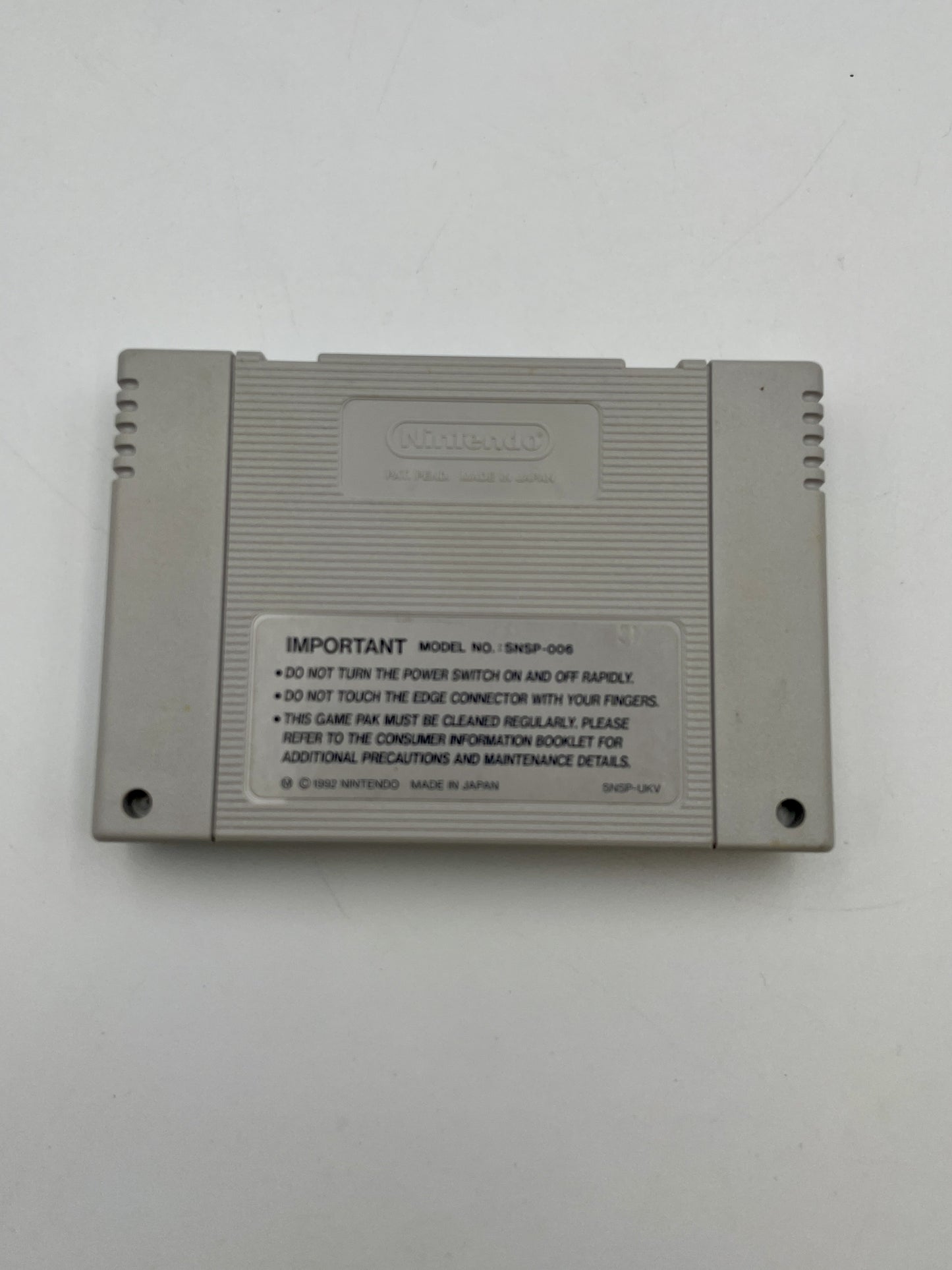 Gray game cartridge with text on a white background