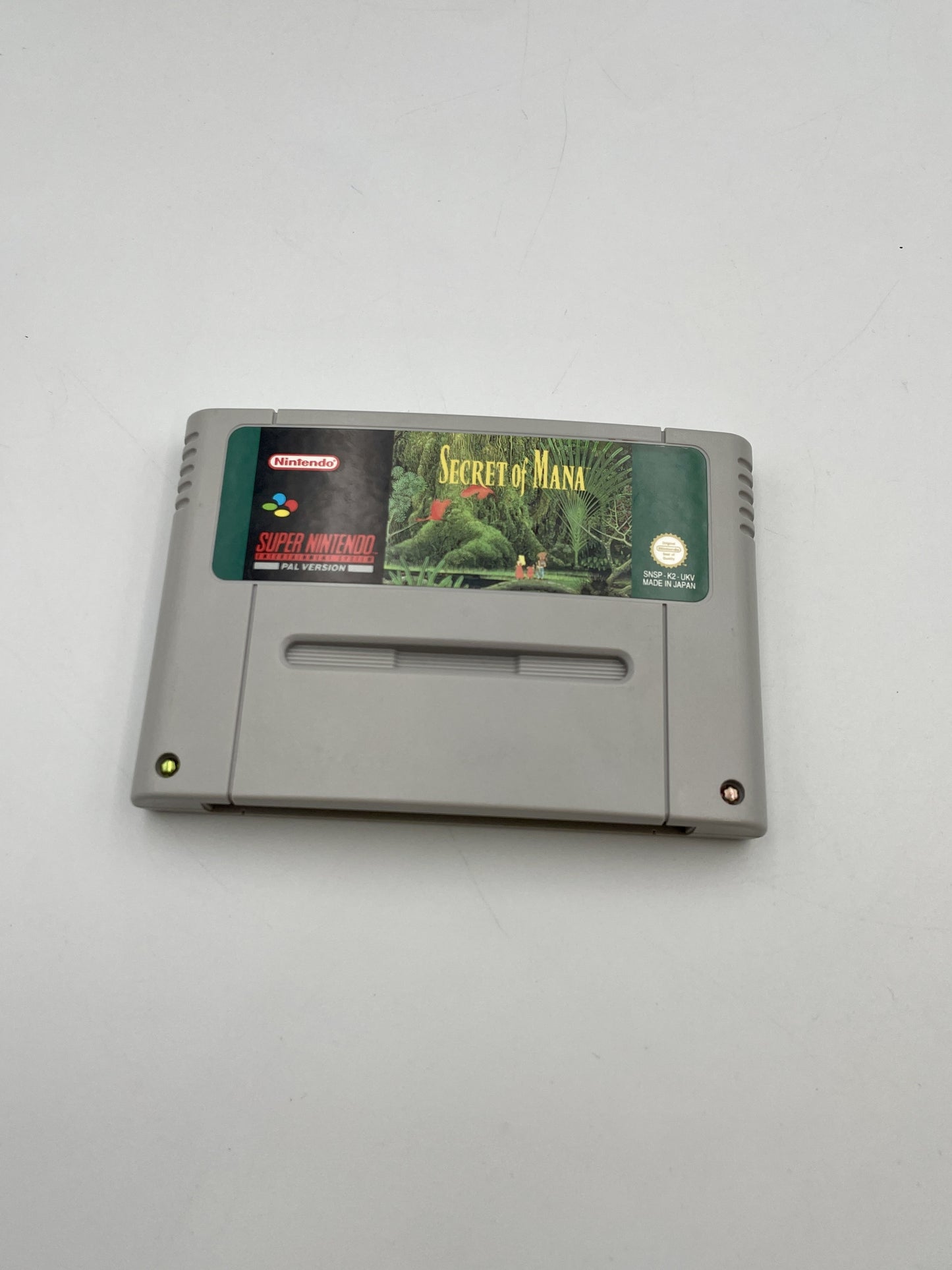SNES game cartridge for 'Secret of Mana' on a white background