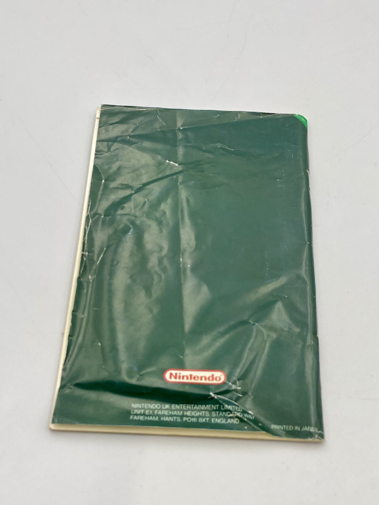 Green Nintendo package on a gray background