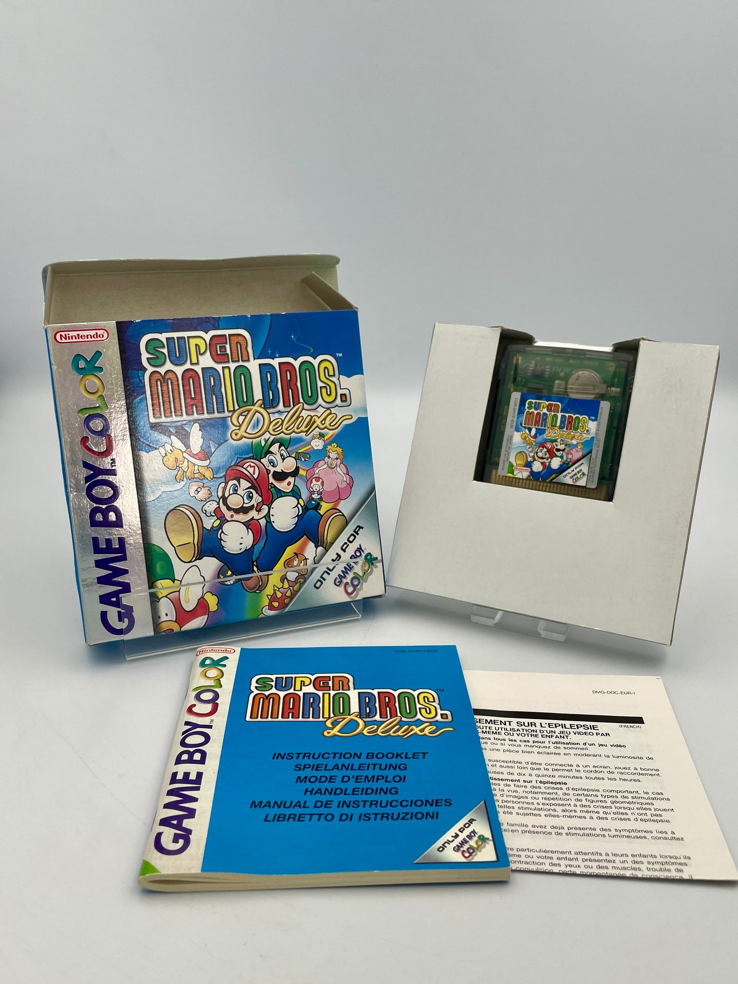 Super Mario Bros. Deluxe Game Boy Color game case with manual and insert on a white background