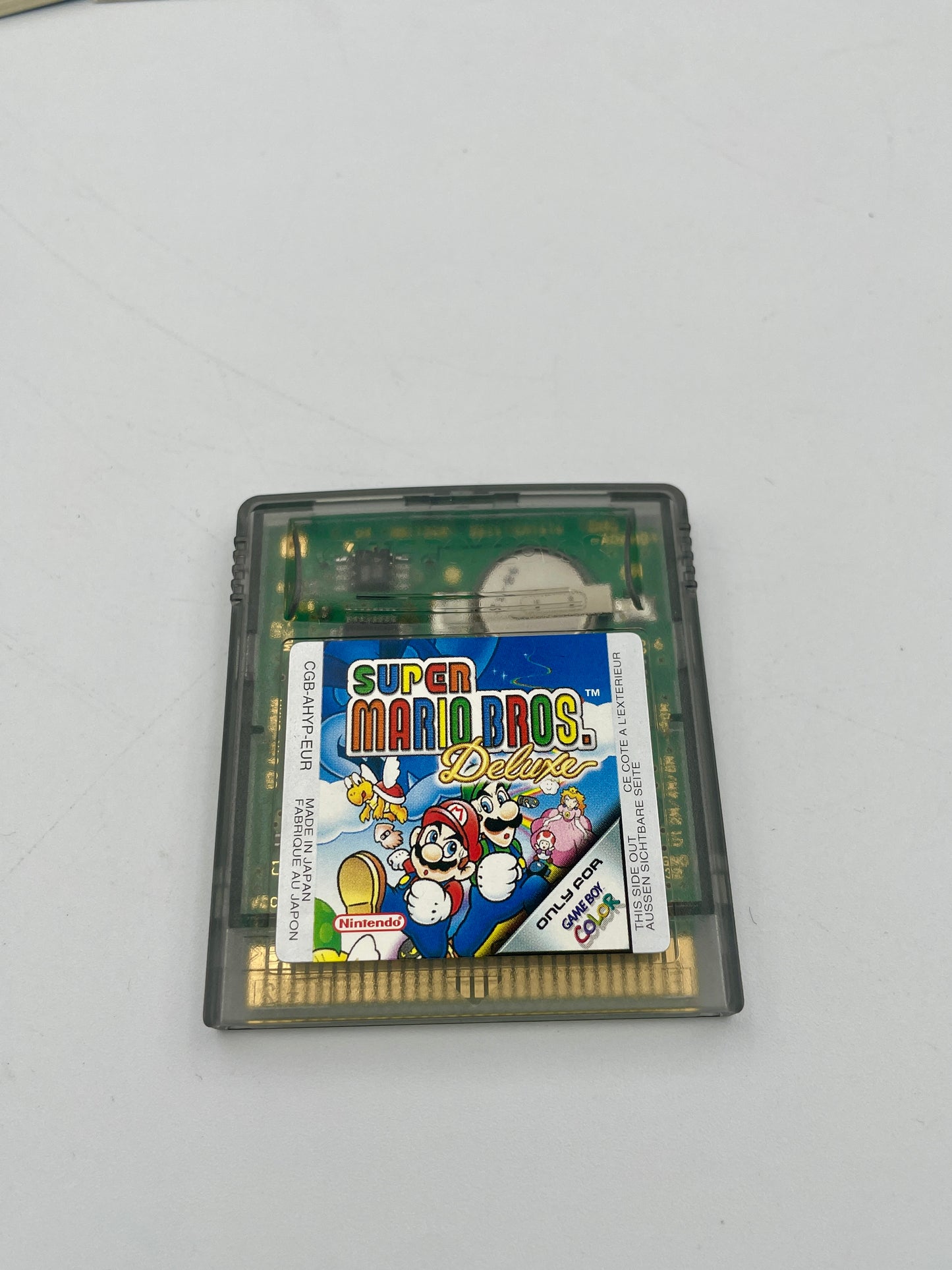 Super Mario Bros. Deluxe game cartridge on a white background