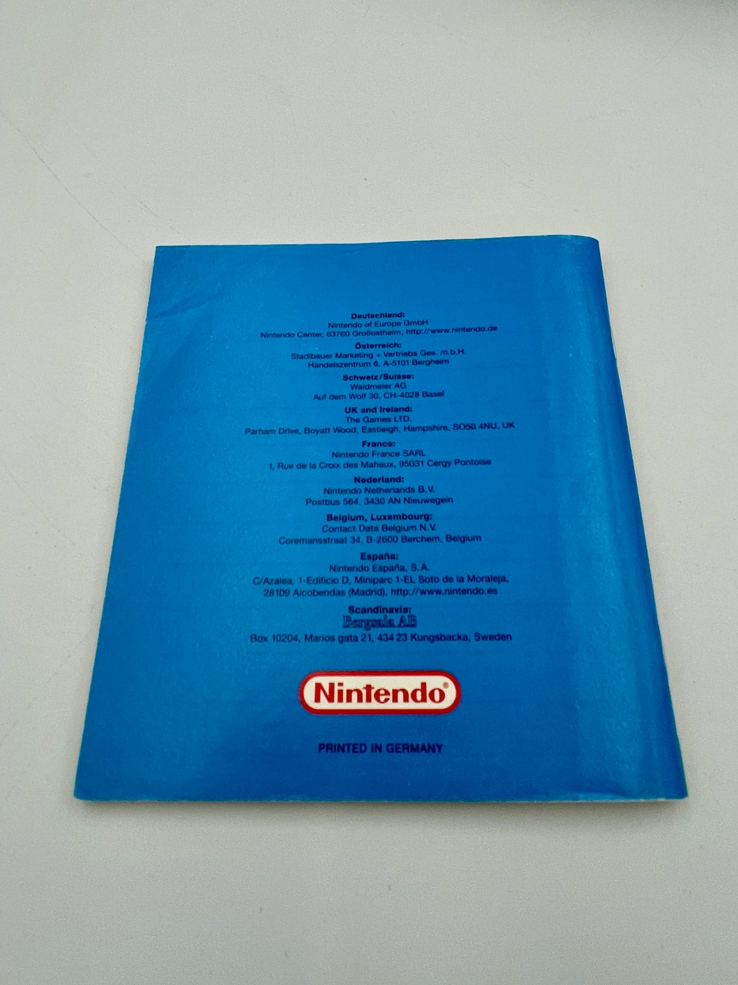Blue Nintendo manual with text and logo on a white background